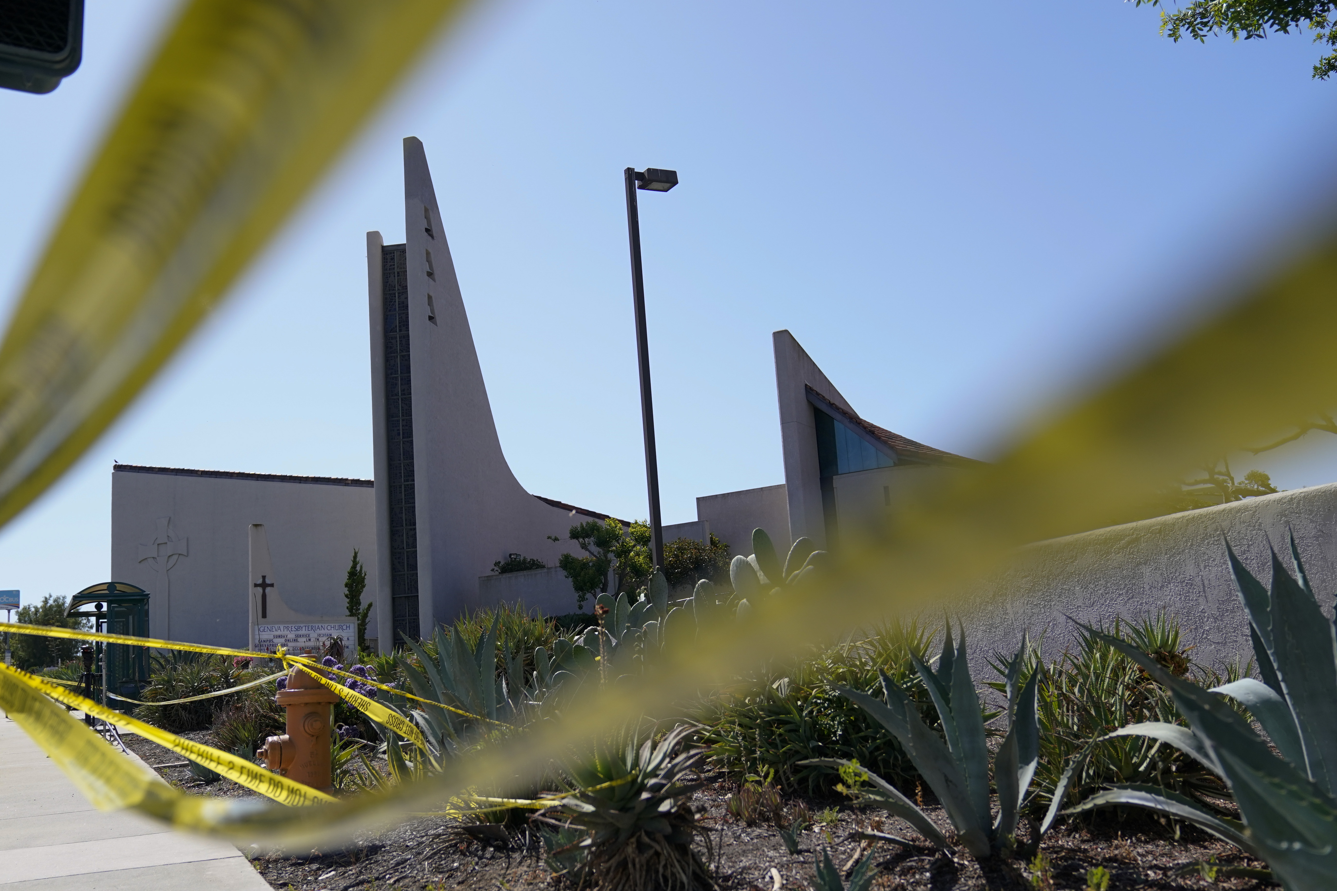 Crime scene tape surrounds Geneva Presbyterian Church on Tuesday, May 17, 2022, in Laguna Woods, Calif. A gunman opened fire on May 15 during a luncheon at the church, killing one and injuring five other members of a Taiwanese congregation that met there. 