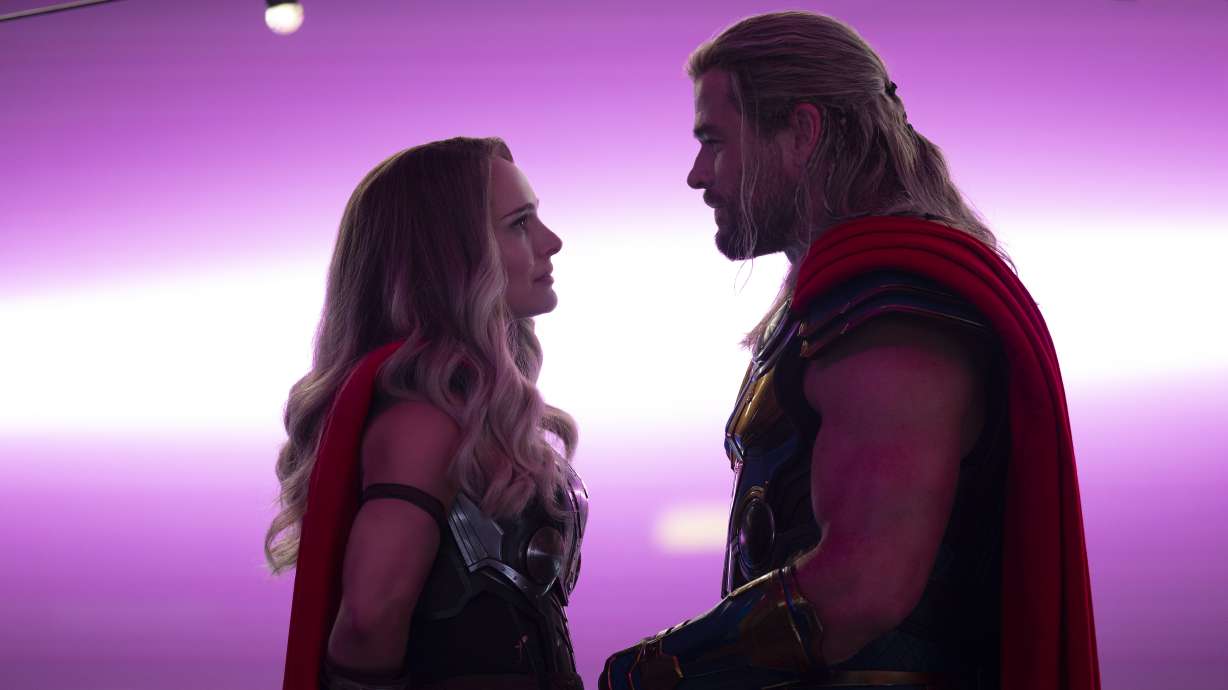 This image released by Marvel Studios shows Natalie Portman, left, and Chris Hemsworth in a scene from "Thor: Love and Thunder."