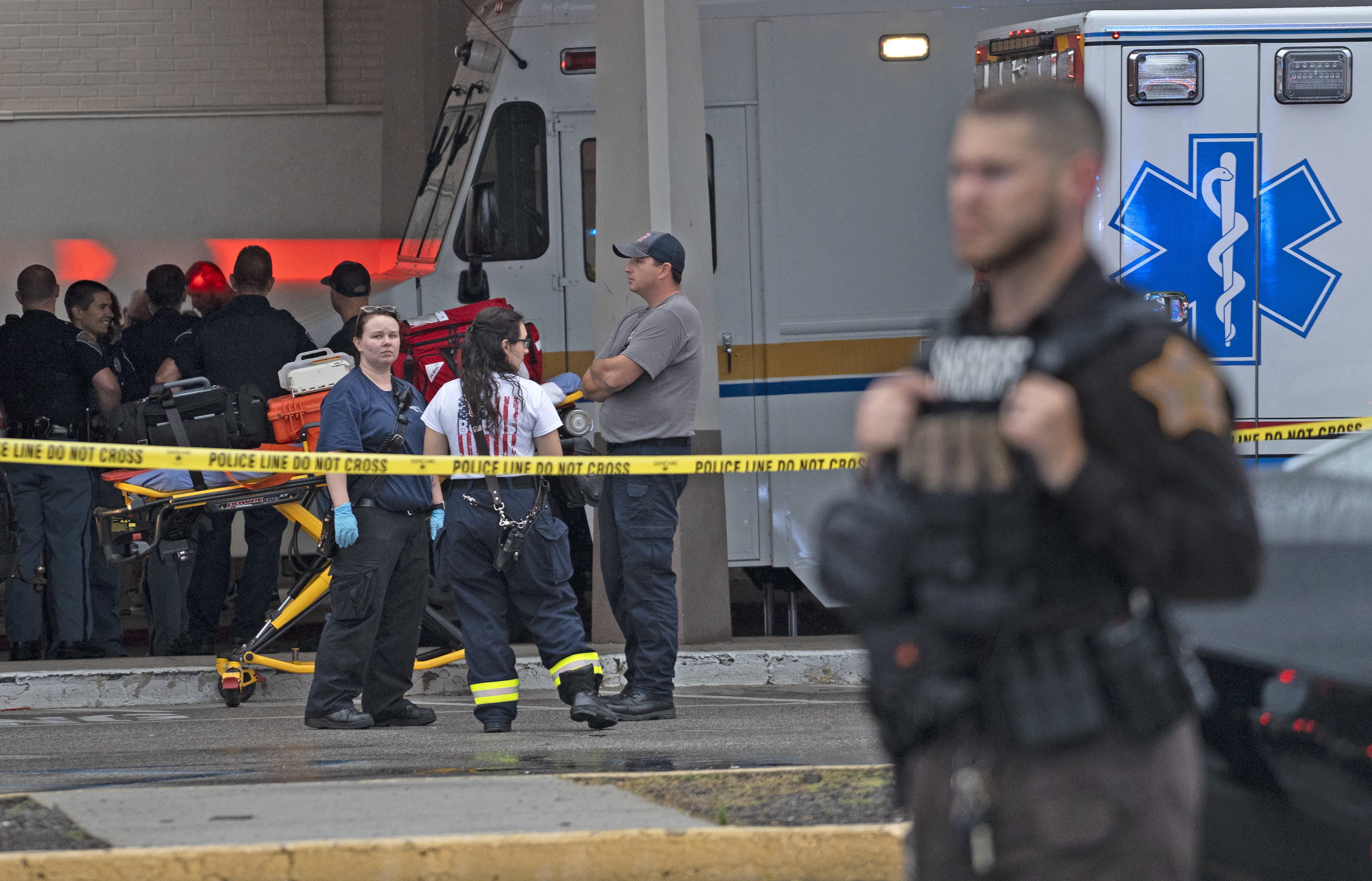 Emergency personnel gather after a deadly shooting Sunday at the Greenwood Park Mall, in Greenwood, Ind.