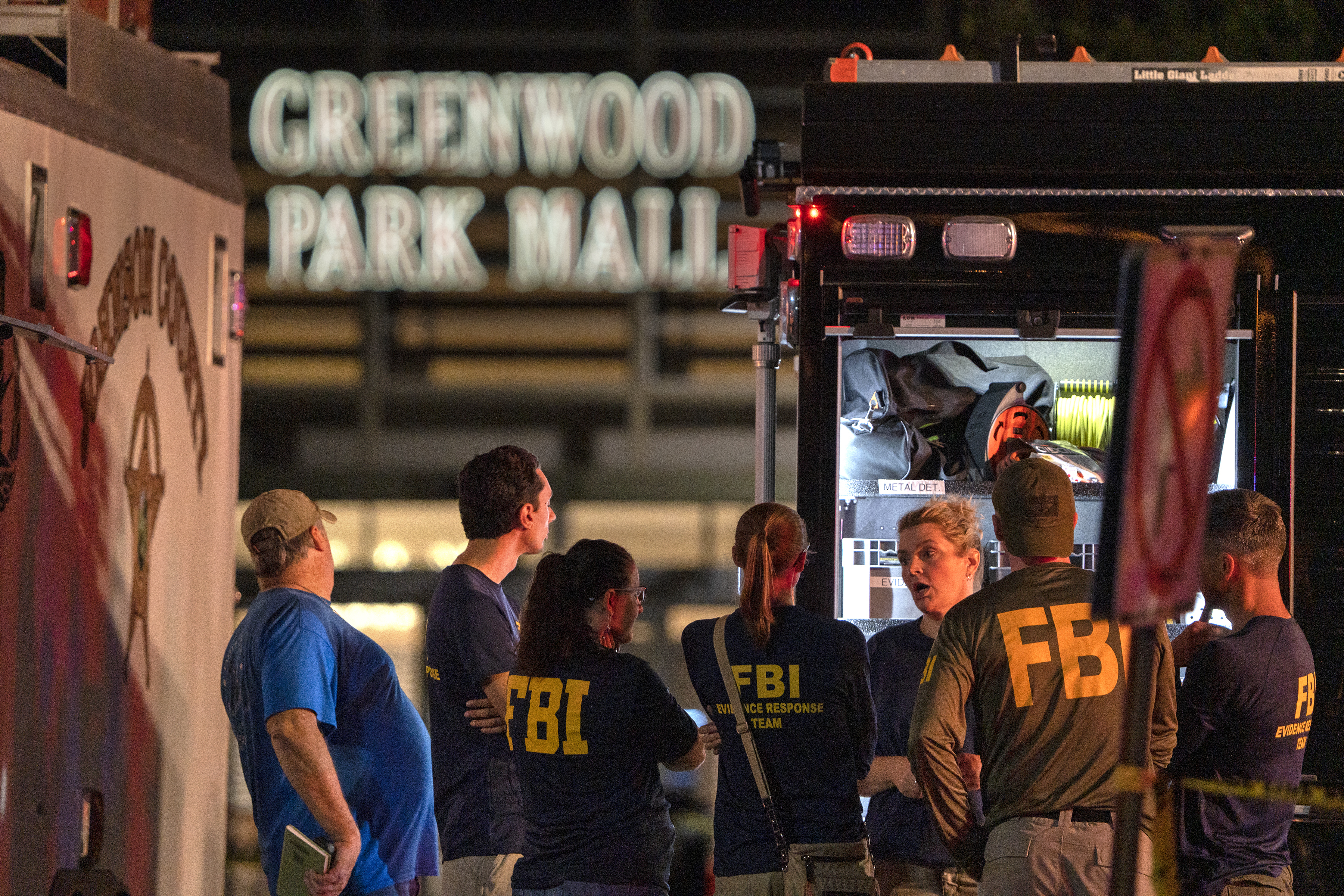 FBI agents gather at the scene of a deadly shooting, Sunday at the Greenwood Park Mall, in Greenwood, Ind. 
