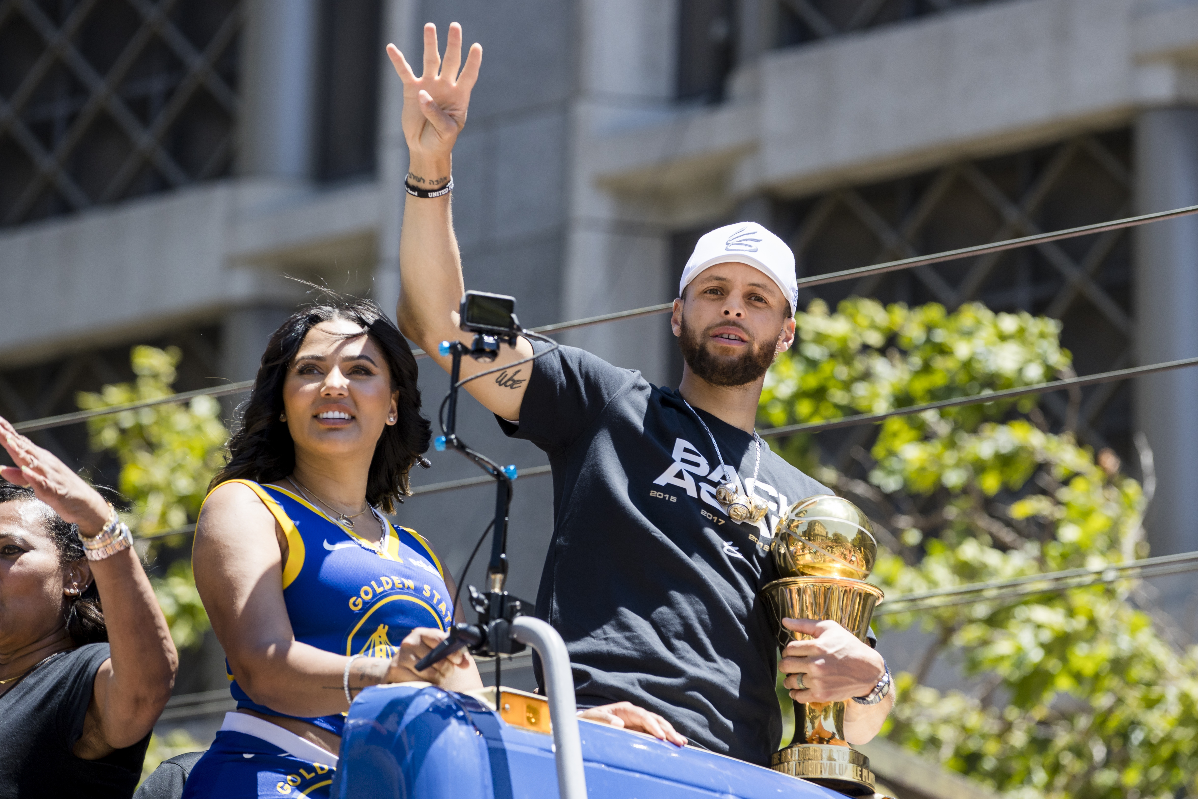 Golden State Warriors' Stephen Curry accompanied by his wife Ayesha, left, holds the Larry O'Brien trophy during the NBA Championship parade in San Francisco, Monday, June 20, 2022, in San Francisco. 