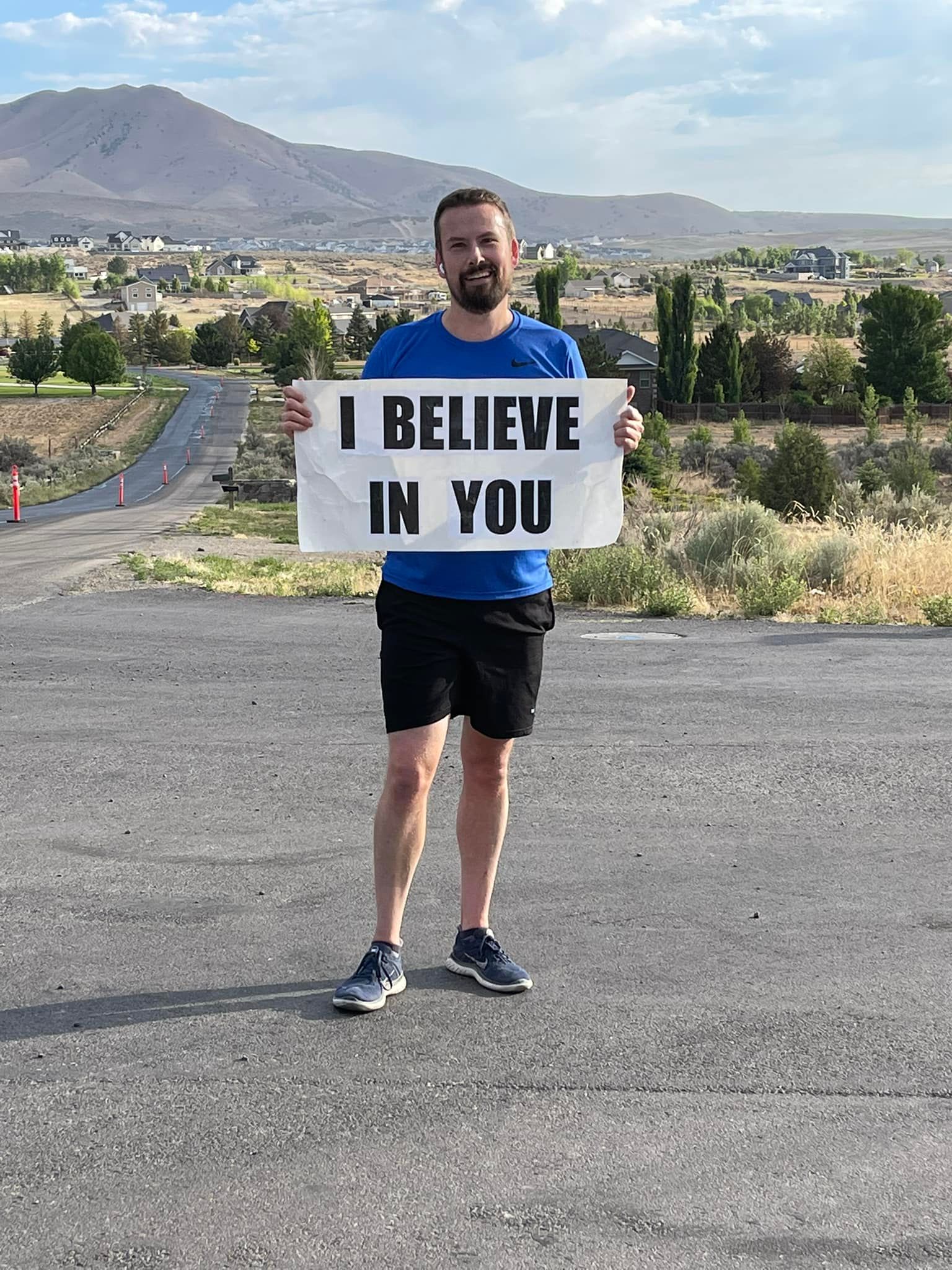 Ben Lyne, of Eagle Mountain, holds his "I believe in you" sign that he carries while he runs. 