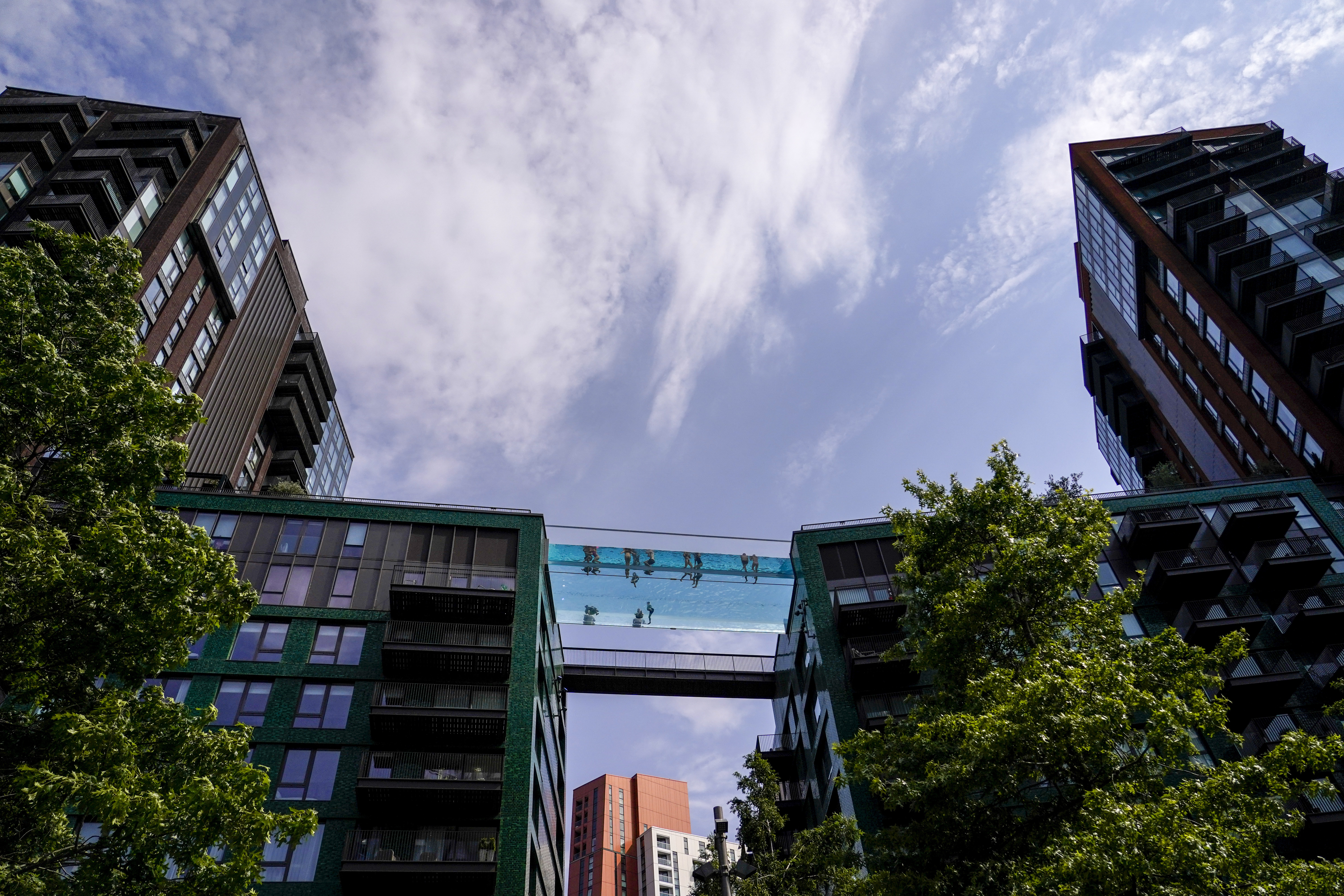 People swim in the elevated pool, called Sky Pool, in London, Monday. Britain shattered its record for highest temperature ever registered amid a heat wave that has seared swaths of Europe.