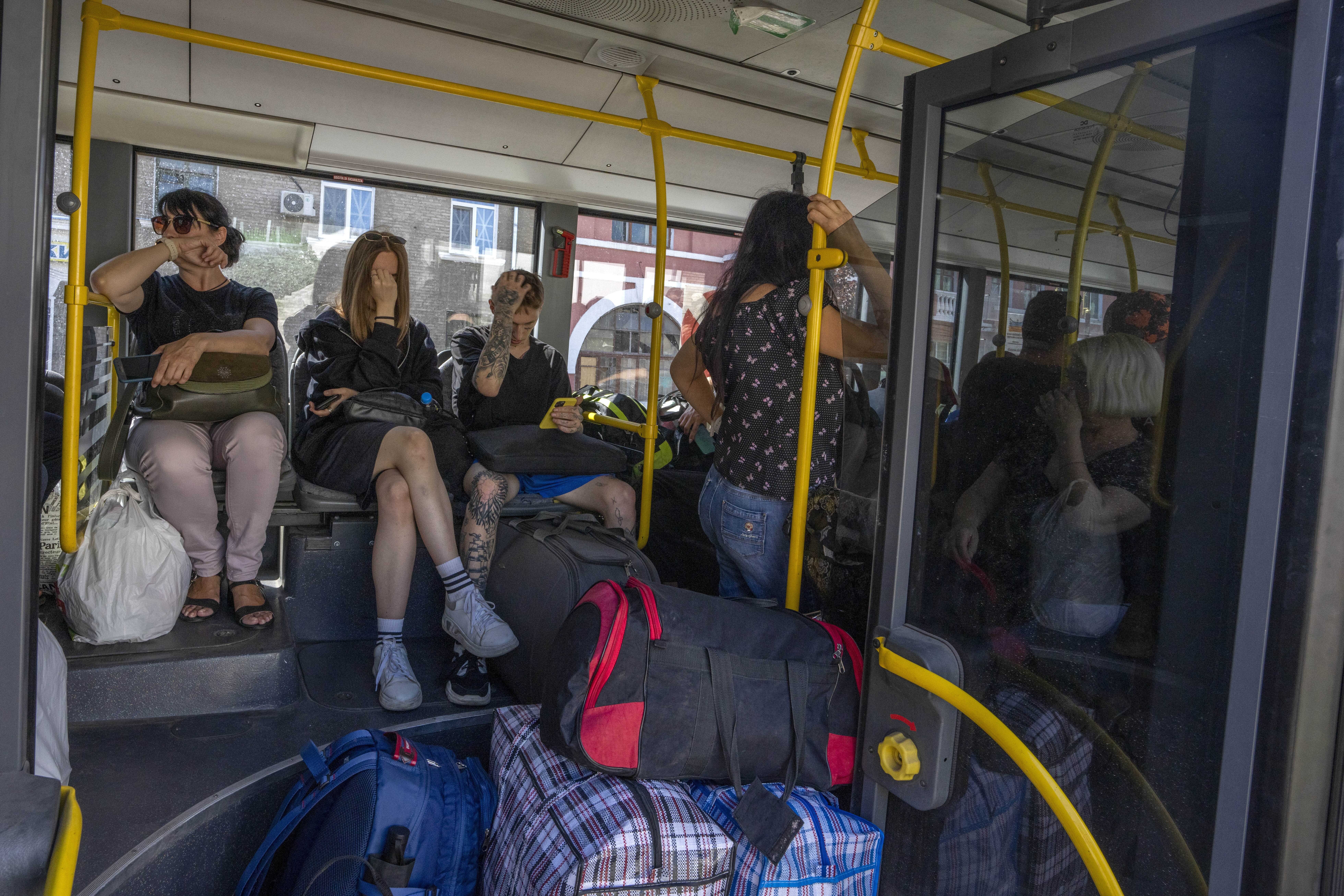 People wait on an evacuation bus, in Kramatorsk, eastern Ukraine, Tuesday. Donetsk Pavlo Kyrylenko said four Russian strikes had been carried out on the city of Kramatorsk, and he urged civilians to evacuate. 