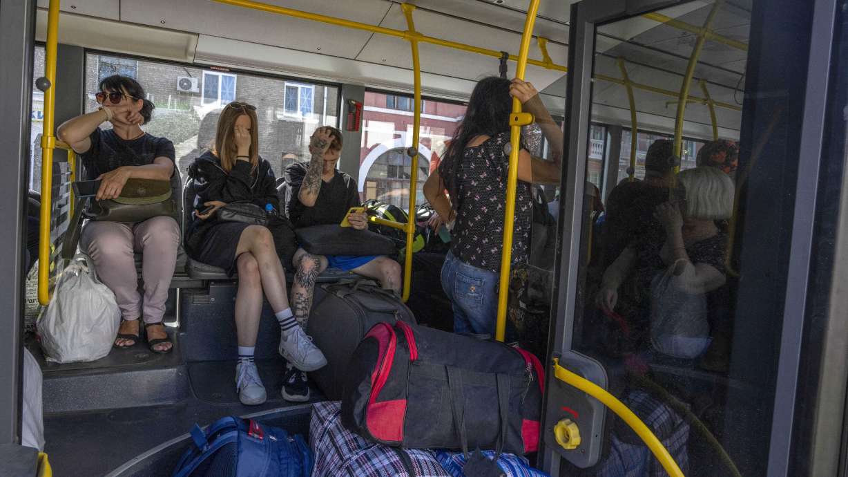 People wait on an evacuation bus, in Kramatorsk, eastern Ukraine, Tuesday. Donetsk Pavlo Kyrylenko said four Russian strikes had been carried out on the city of Kramatorsk, and he urged civilians to evacuate.