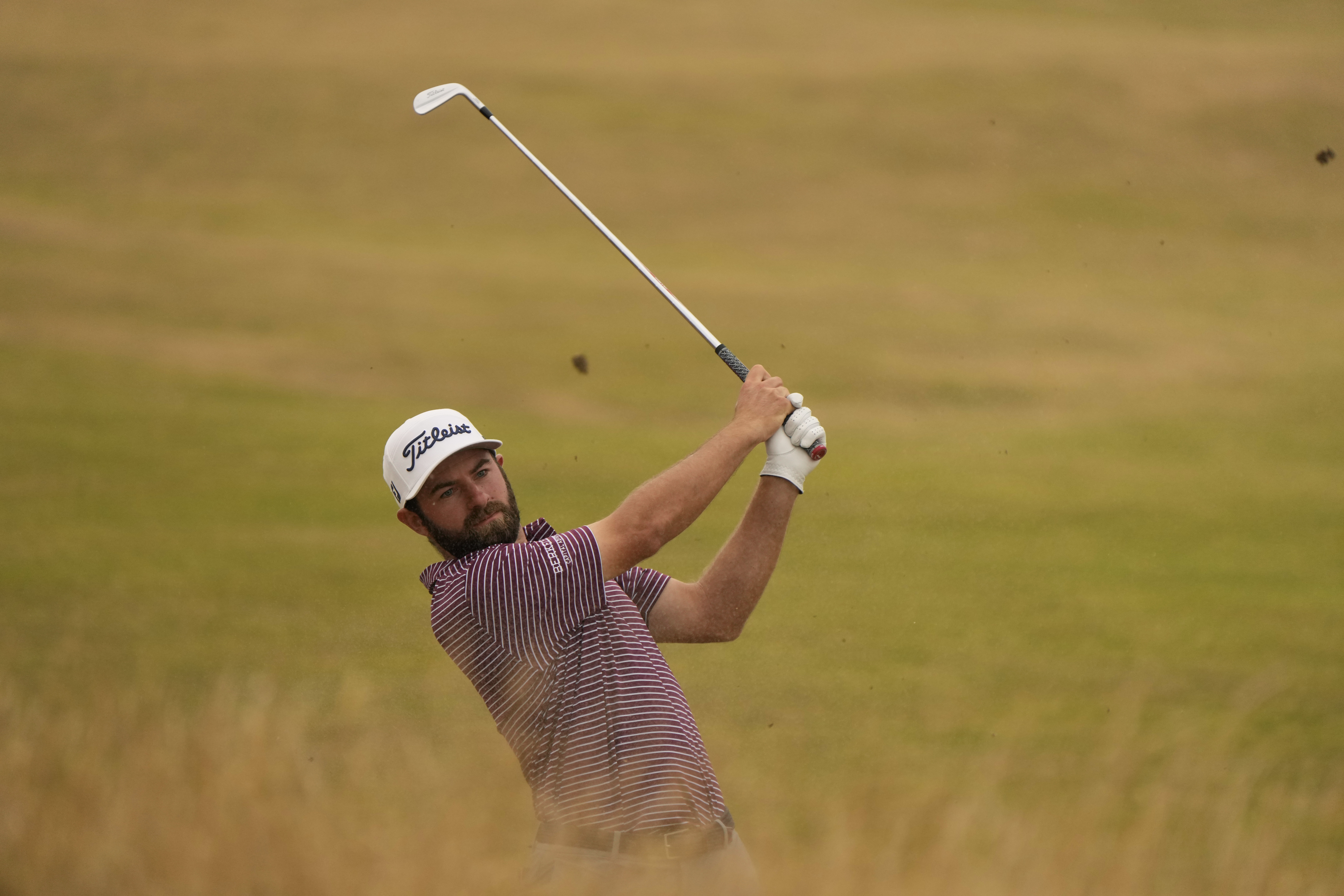Cameron Young of the US plays out of the rough on the 13th fairway during the final round of the British Open golf championship on the Old Course at St. Andrews, Scotland, Sunday July 17, 2022. 