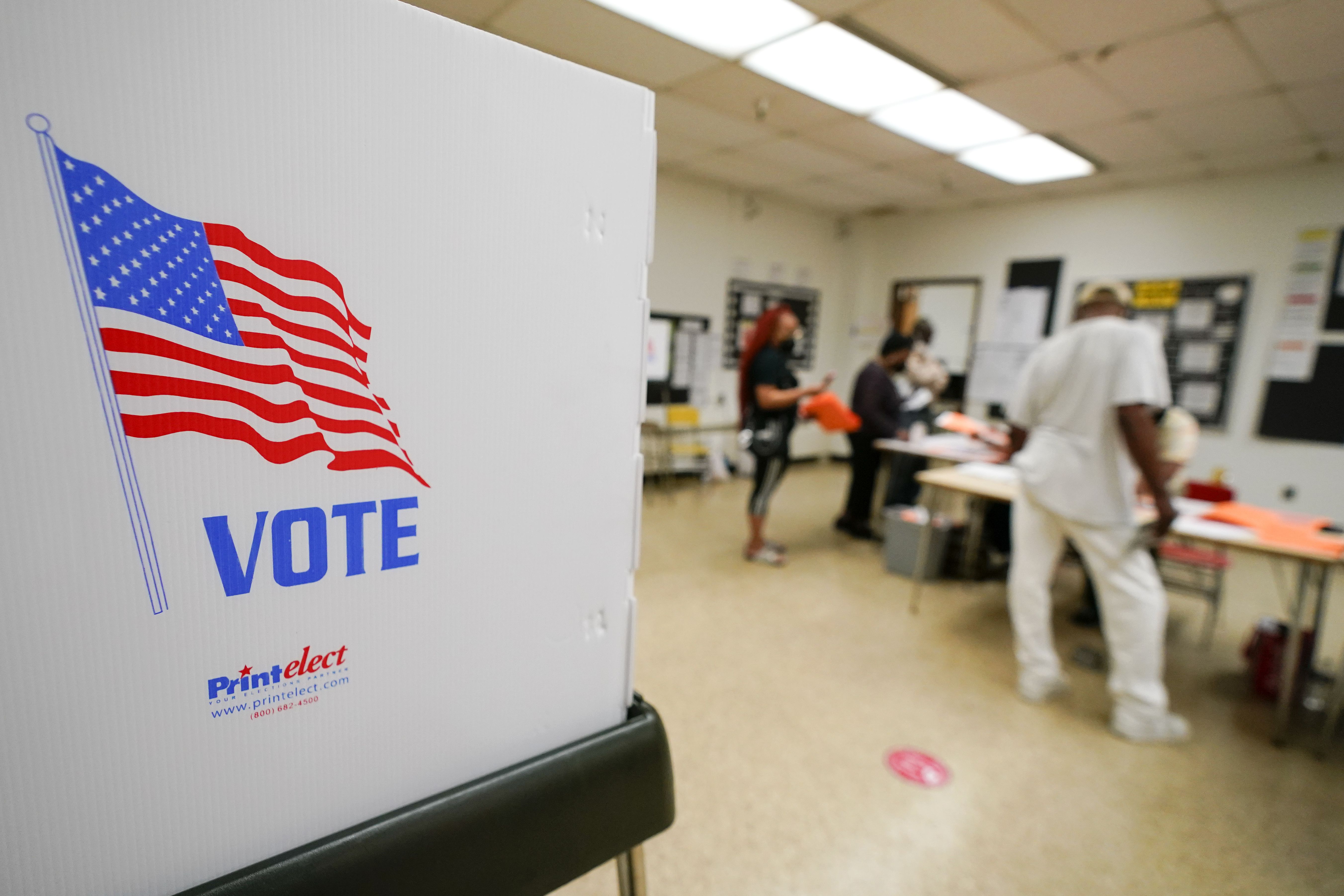 People check in to vote at Edmondson Westside High School during Maryland’s primary election on Tuesday, in Baltimore.