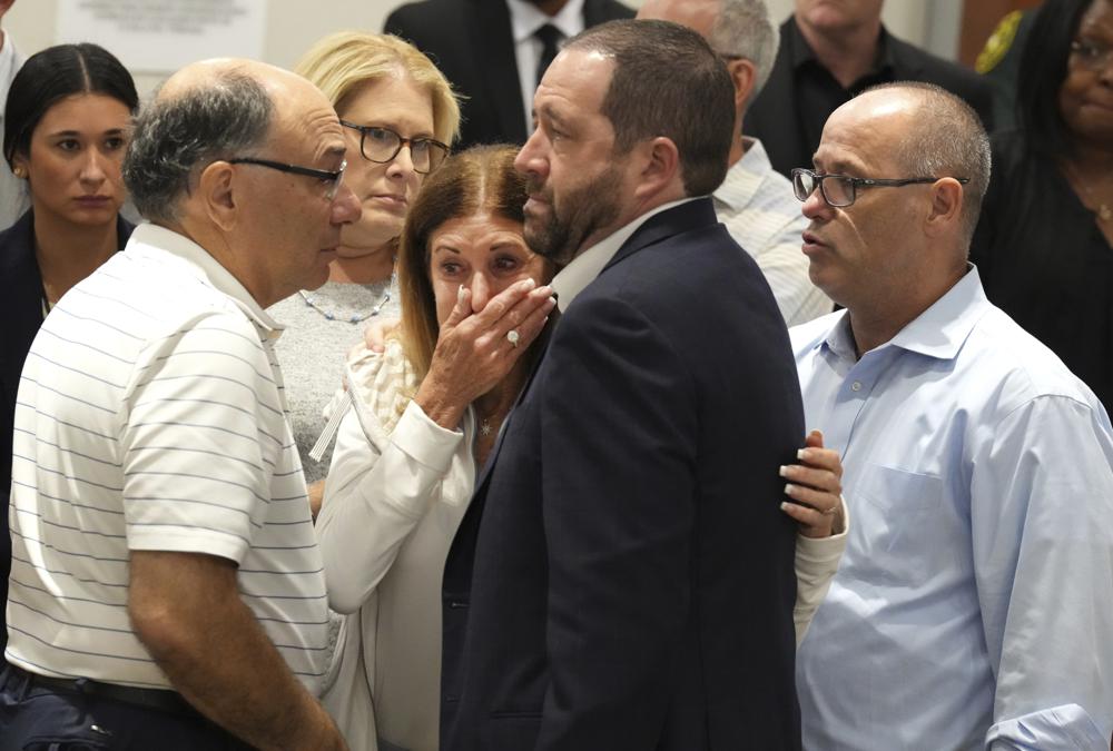 Linda Beigel Schulman, center, mother of Scott Beigel, is comforted by other victims' family during the penalty phase of Marjory Stoneman Douglas High School shooter Nikolas Cruz's trial at the Broward County Courthouse in Fort Lauderdale, Fla., Tuesday. Cruz previously plead guilty to all 17 counts of premeditated murder and 17 counts of attempted murder in the 2018 shootings.