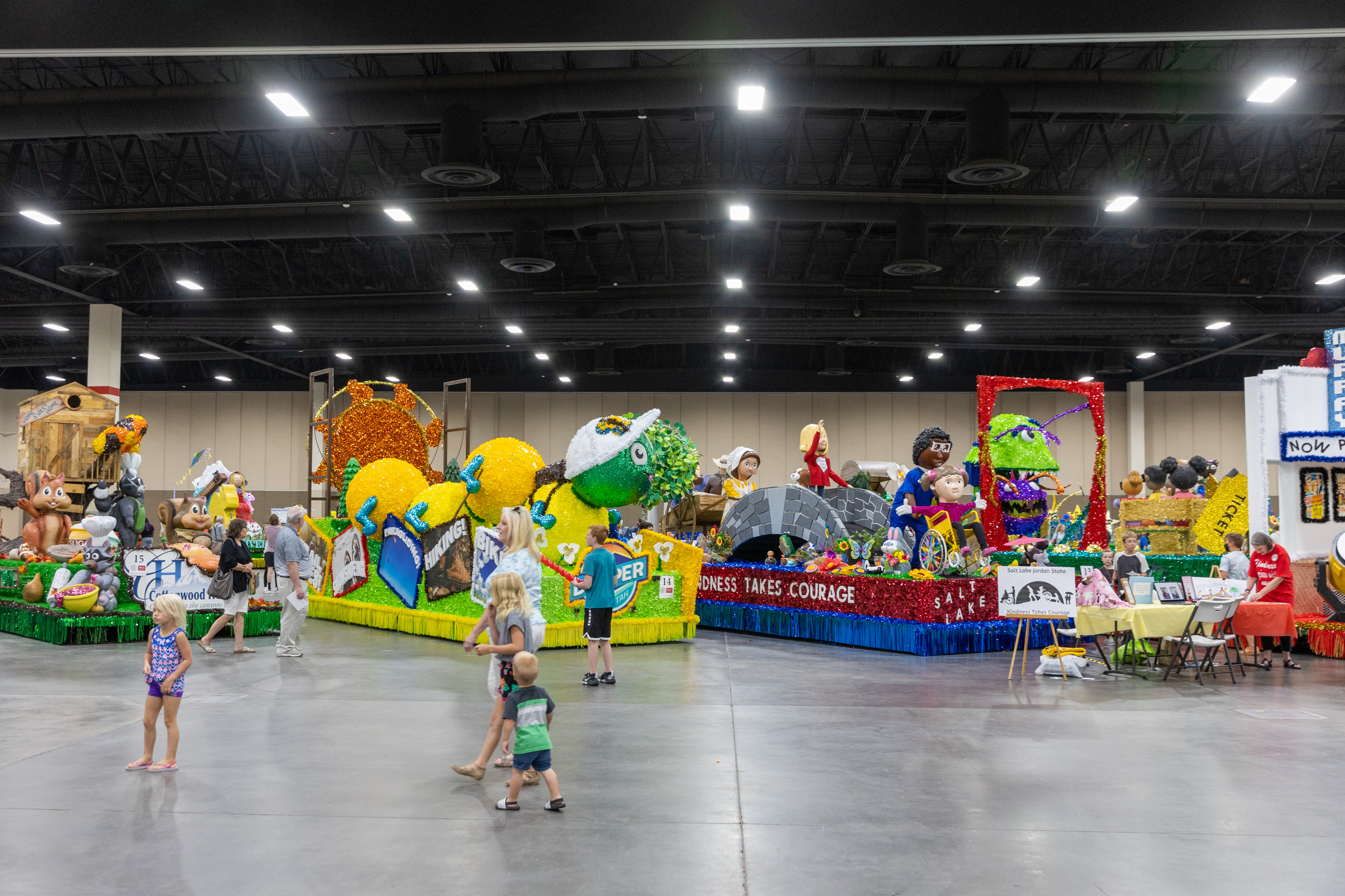Attendees walk around at the Days of ’47 Float Preview Party inside of the Mountain America Expo Center in Sandy on Monday.