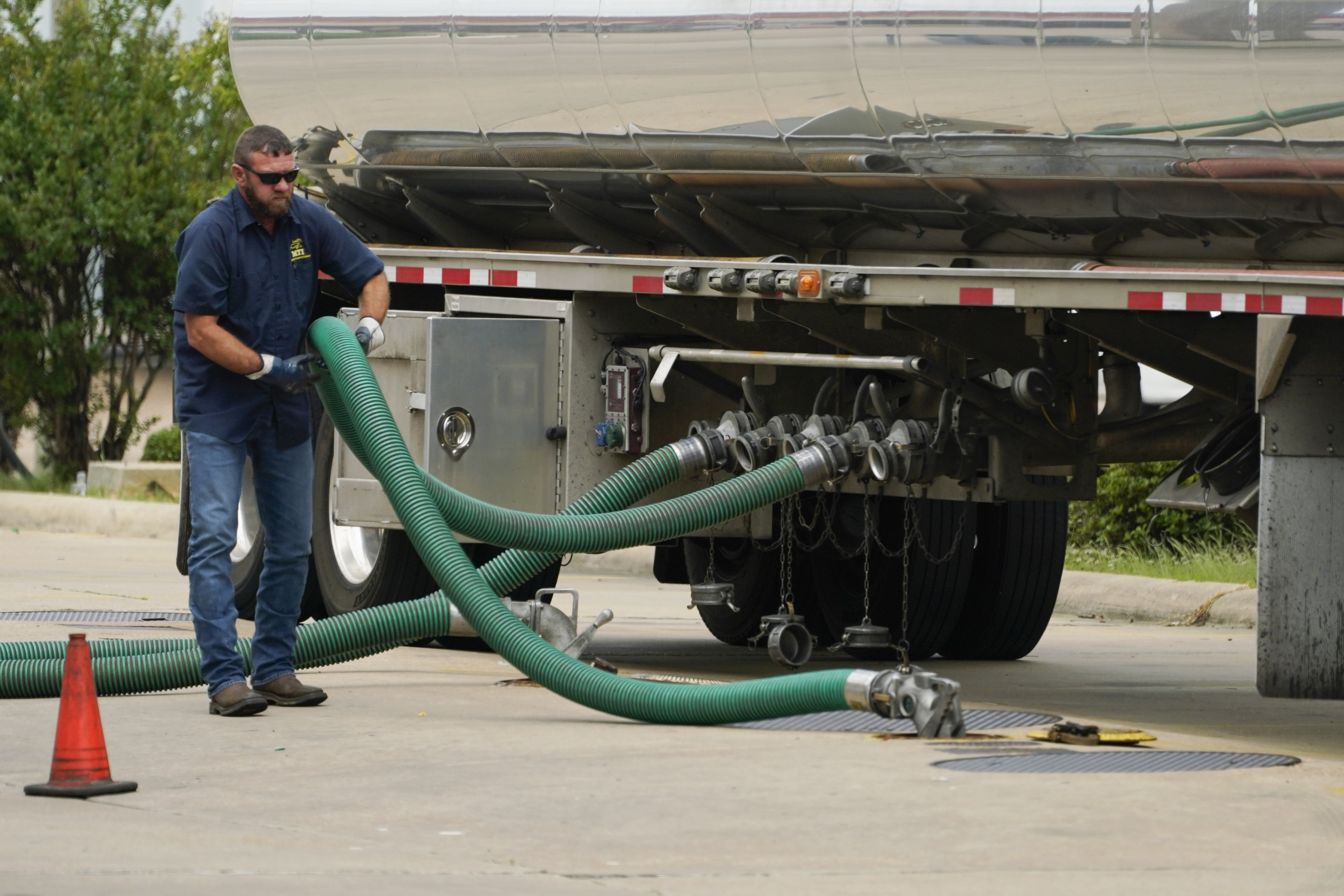 A gas tank driver adjusts his hose hookup to an underground tank on May 24 in Jackson, Miss. High diesel prices are driving up the cost of most goods, from groceries to Amazon orders and furniture, as nearly everything that is delivered, whether by truck, rail or ship, uses diesel fuel.