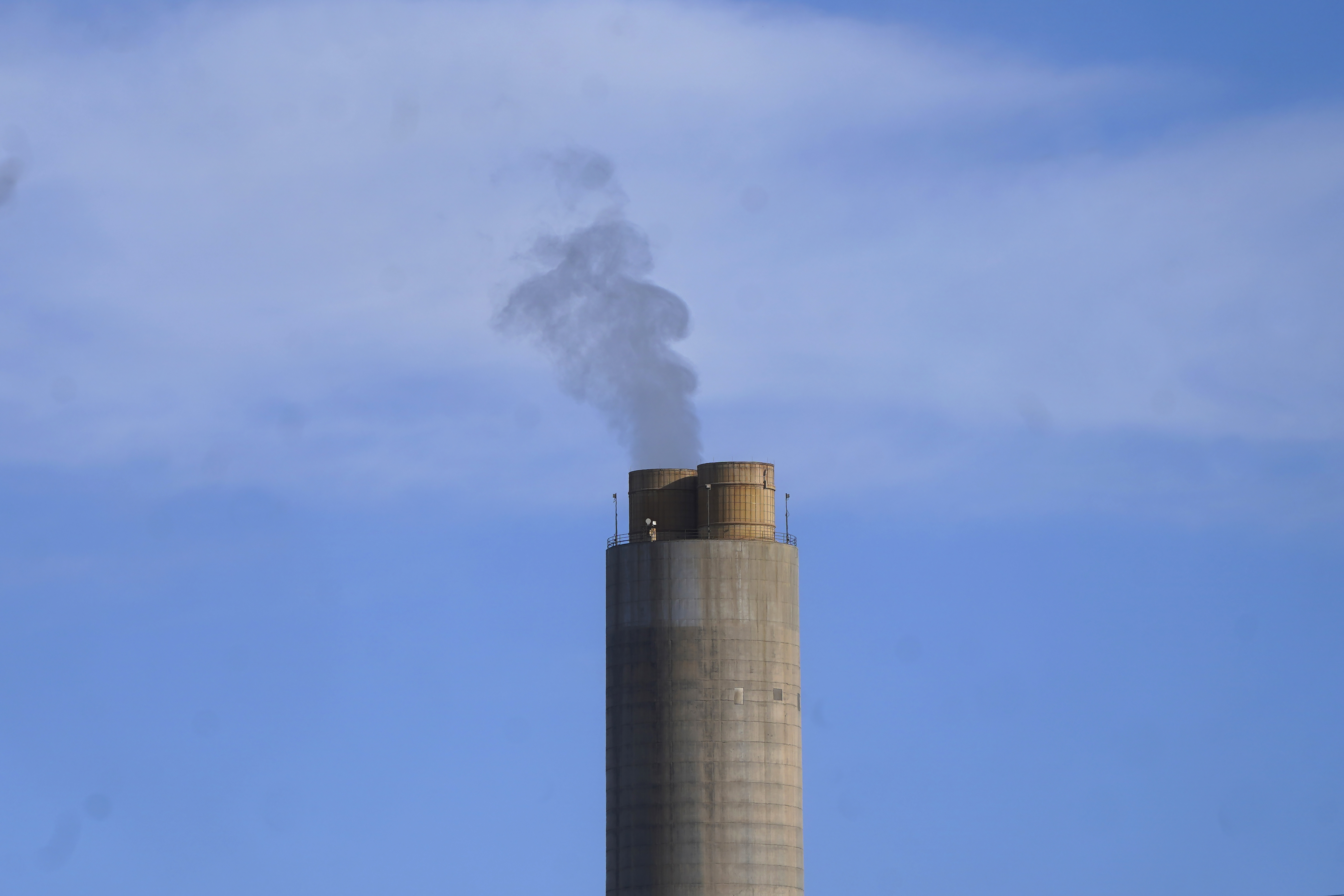 A smokestack stands at a coal plant on June 22, in Delta. Developers in rural Utah who want to create big underground caverns to store hydrogen fuel won a $504 million loan guarantee this spring. They plan to convert the site of the plant completely to cleanly made hydrogen by 2045.