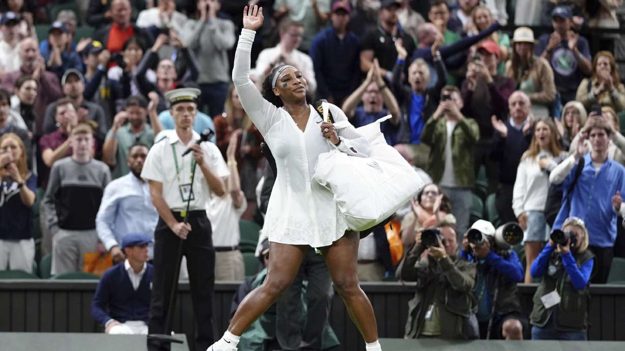 Serena Williams of the US waves as she leaves the court after losing to France's Harmony Tan in a first round women’s singles match on day two of the Wimbledon tennis championships in London, Tuesday, June 28, 2022.