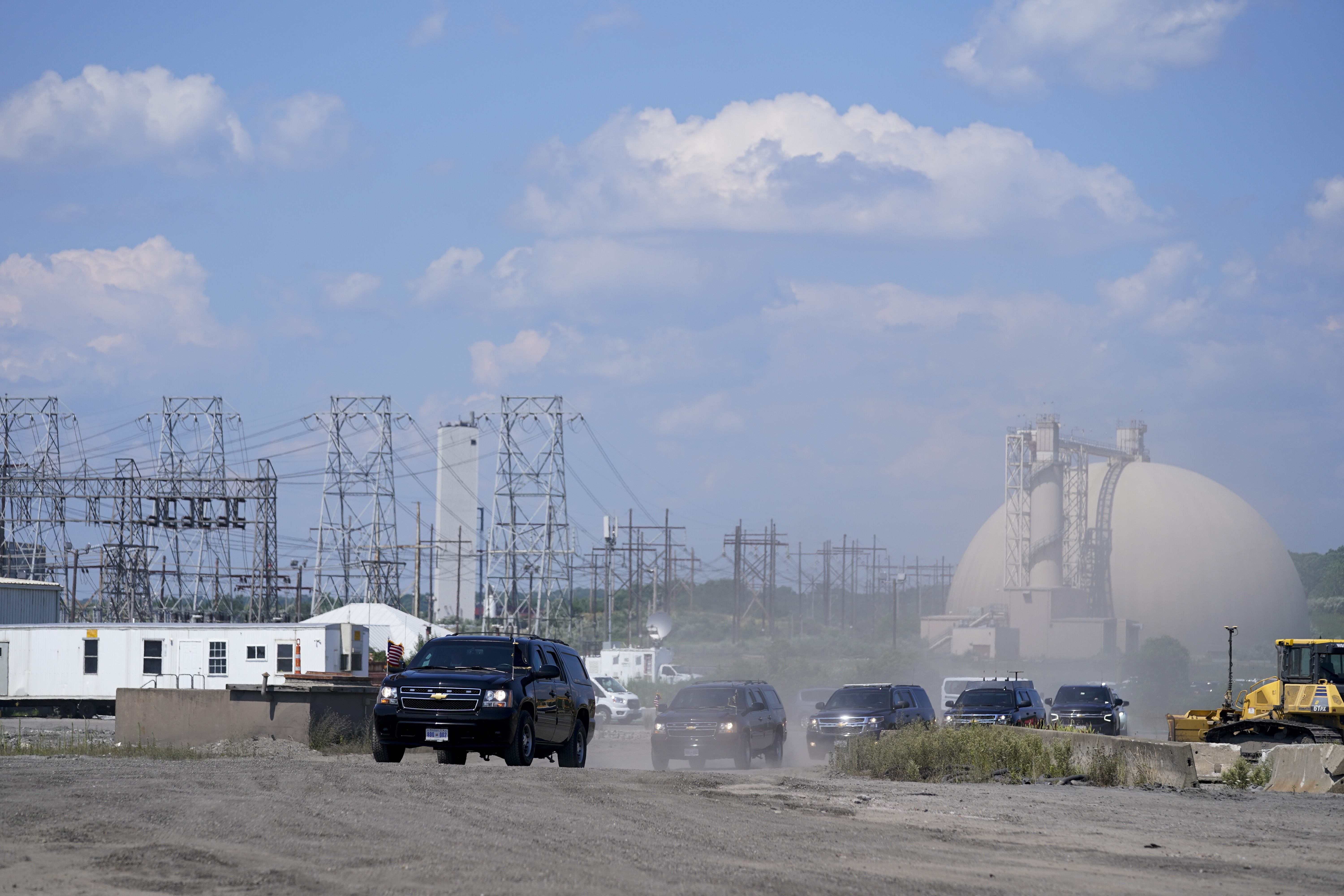 The motorcade for President Joe Biden arrives for an event at Brayton Power Station, Wednesday, in Somerset, Mass.