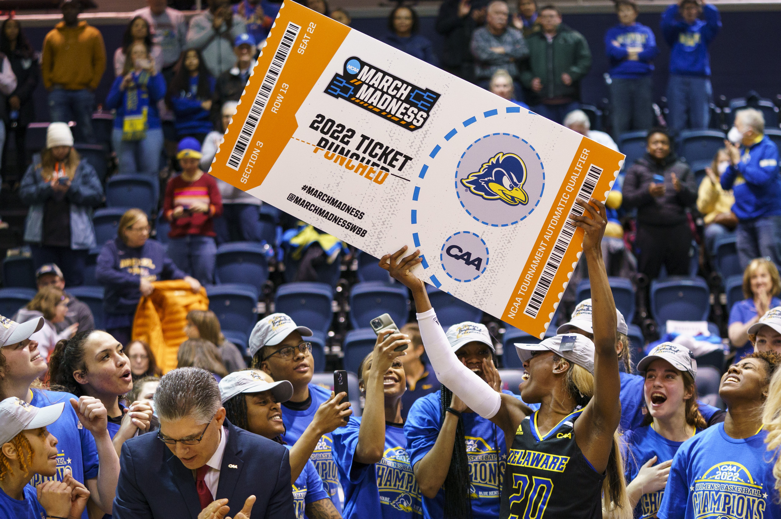 FILE - Delaware's Jasmine Dickey holds up the March Madness ticket following the second half of an NCAA college basketball championship game against Drexel in the Colonial Athletic Association Conference Tournament, Sunday, March 13, 2022, in Philadelphia. Delaware won 63-59. The NCAA has adequately addressed nine of 23 recommendations for creating comparable NCAA Tournament experiences for men's and women's basketball players, according to a progress report released Wednesday. July 20, 2022. 