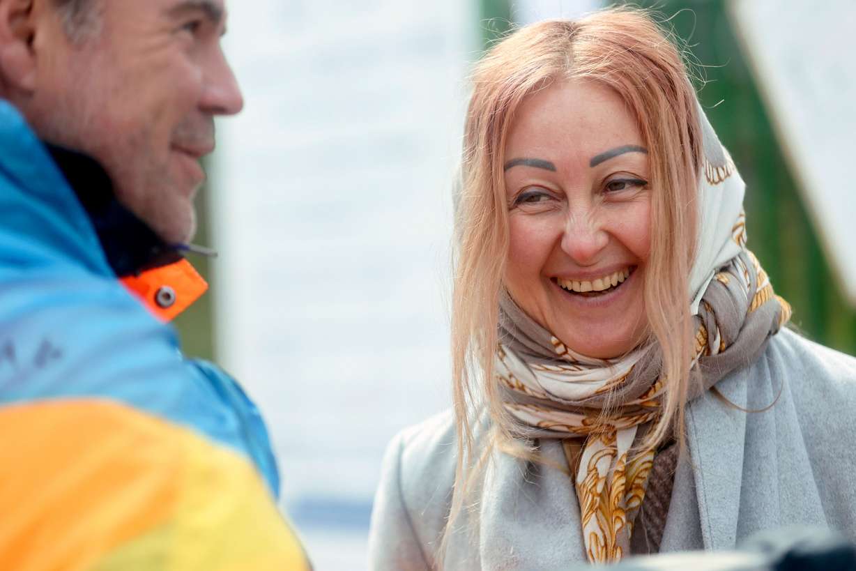 Anzhela Kumurxhi, a refugee from Mariupol, Ukraine, talks with a volunteer at the Ukrainian-Polish border in Medyka, Poland, on Tuesday, April 19, 2022.