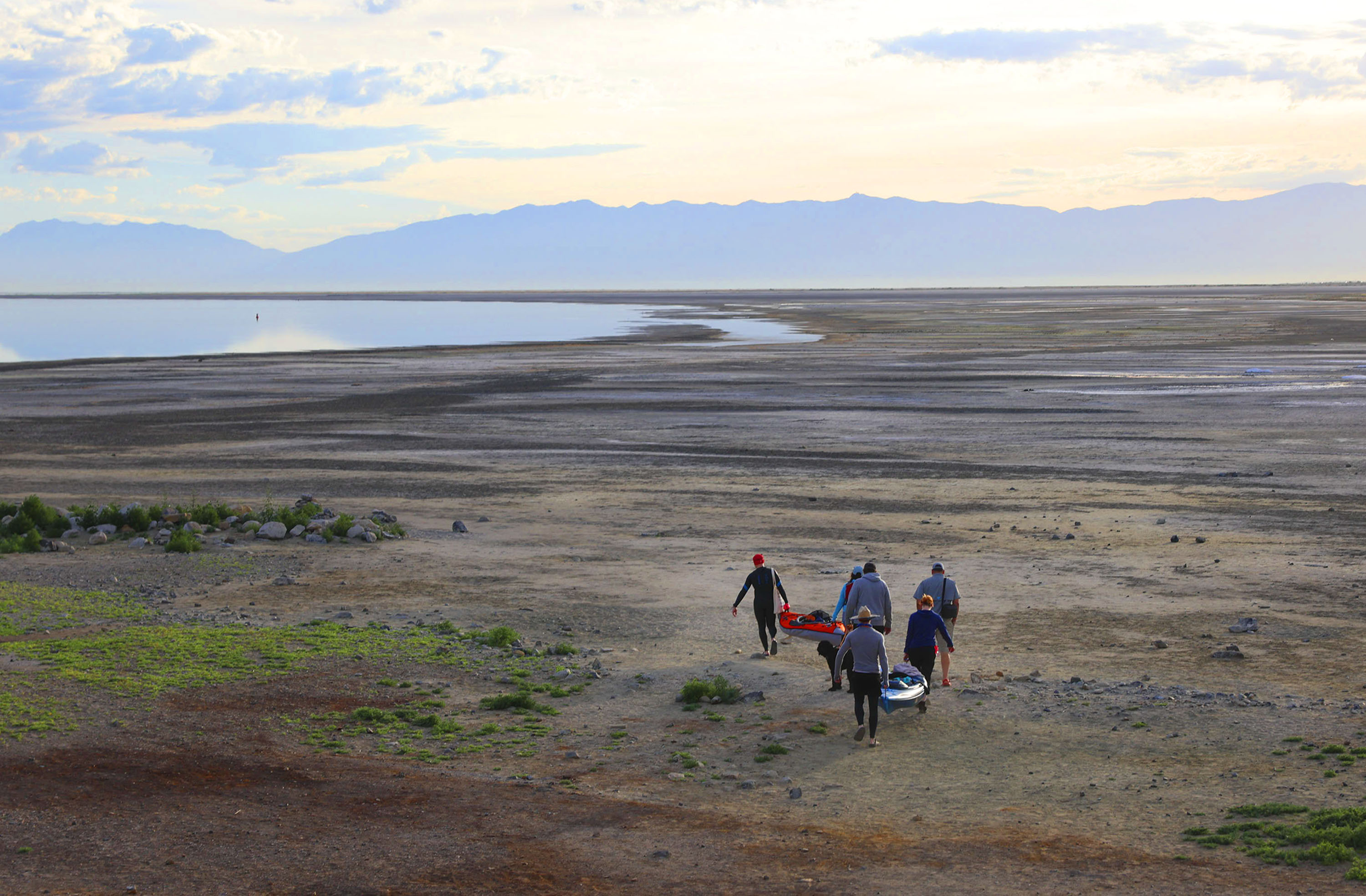 Competitors carry kayaks to the water before an open swim competition at Great Salt Lake State Park in Magna on June 11. The U.S. Senate passed a bill co-sponsored by Utah Sen. Mitt Romney on Wednesday that earmarks $5 million every year over five years for the U.S. Geological Survey to study saline lakes throughout the Great Basin.