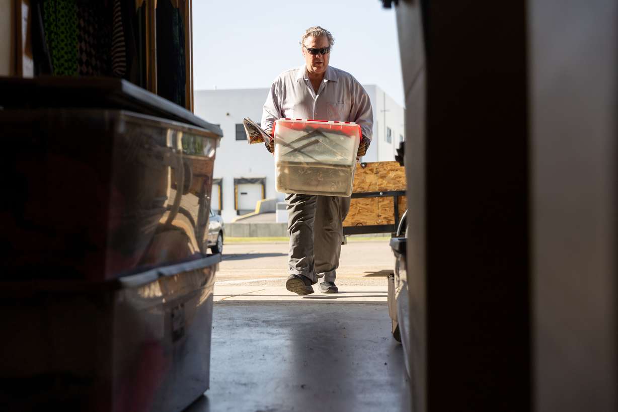 Derryl Yeager carries inventory as he prepares to sell off costumes and close Odyssey Dance Theater in Draper on Tuesday. Yeager and his wife, Cheryl Yeager, started Odyssey Dance Theater 28 years ago.