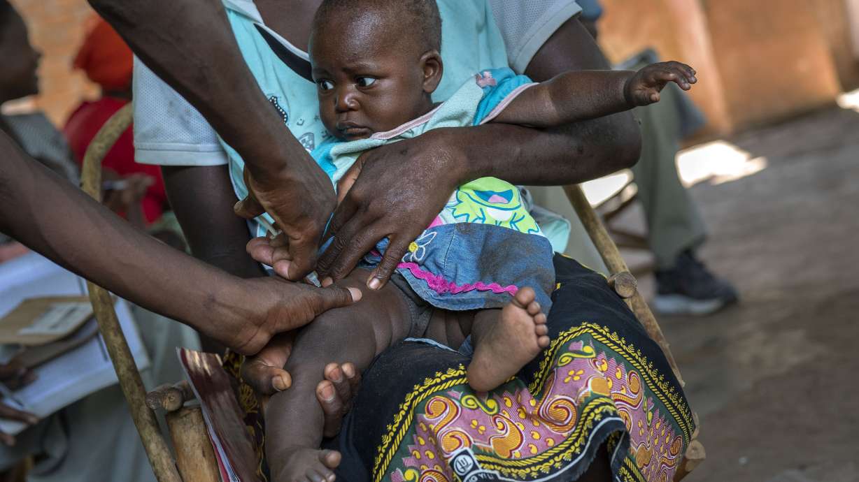 A baby from the Malawi village of Tomali is injected with the world's first vaccine against malaria in a pilot program, in Tomali, Dec. 11, 2019. As the World Health Organization announces Thursday, July 21, 2022 the next step in its rollout of the world's first authorized malaria vaccine in several African countries, the Bill and Melinda Gates Foundation says it will no longer financially support the shot.