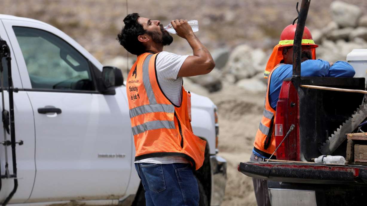 A construction worker drinks water in temperatures that have reached well above triple digits in Palm Springs, California, on June 20. More than 85% of Americans are bracing for temperatures above 90 degrees Fahrenheit through the weekend.