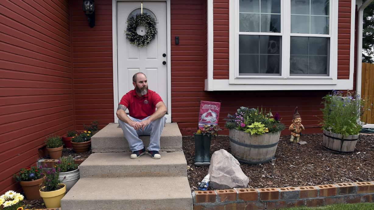 Kyle Tomcak sits in front of his house in Aurora, Colo., on Monday, July 18. Tomcak was in the market for a home priced around $450,000 for his in-laws and he and his wife bid on every house they toured, regardless of whether they fell in love with the home. He said his search became increasingly dispiriting as he not only lost out to investors fronting cash offers $100,000 over asking price but as mortgage rates started to balloon. He has since pulled out of the housing search.