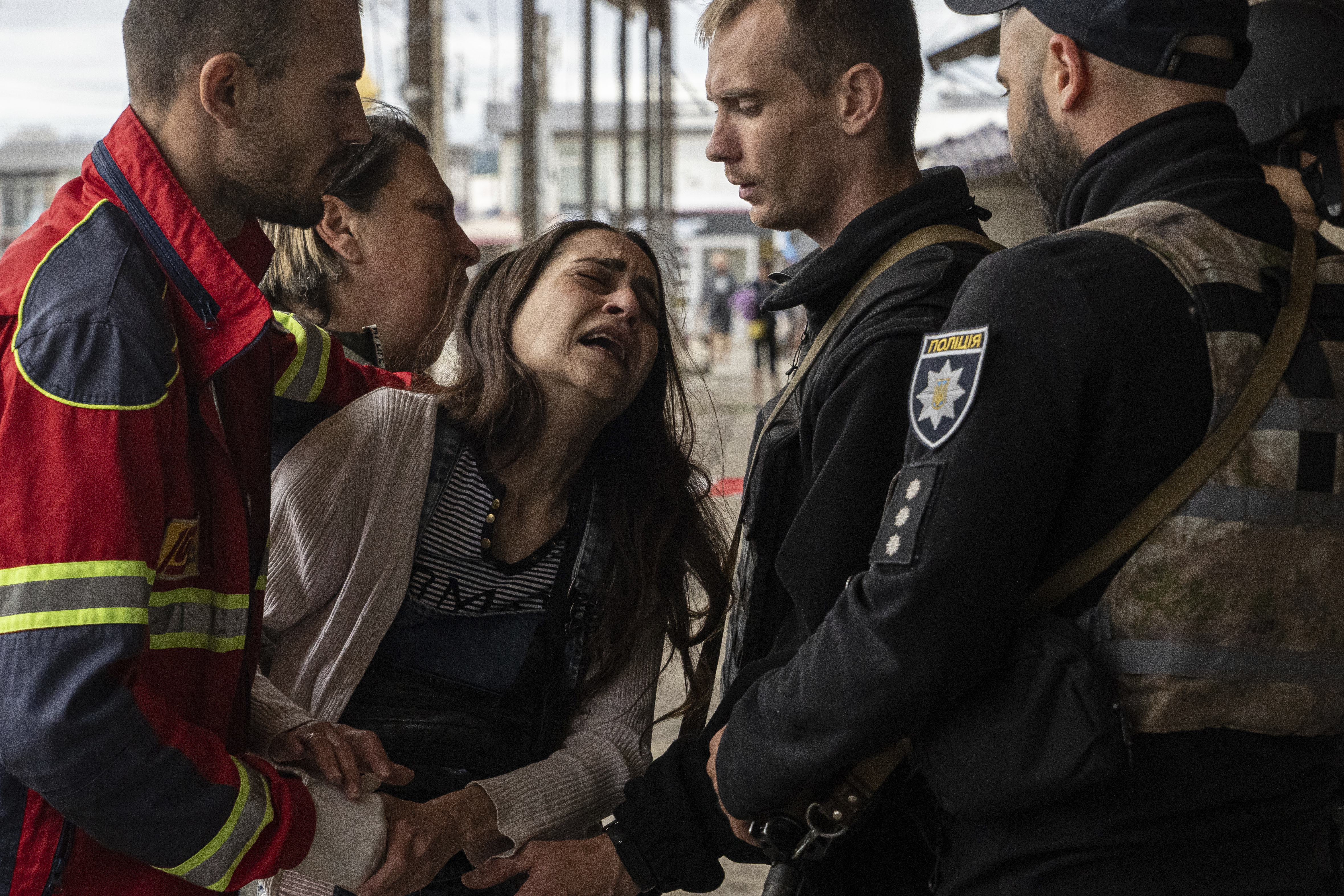 Sabina, centre, cries after her husband Artem Pogorelets was killed by Russian shelling at Barabashovo market in Kharkiv, Ukraine, Thursday.