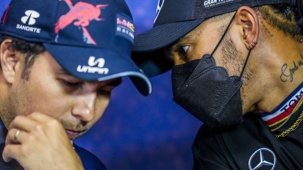 Mercedes driver Lewis Hamilton of Britain, right, talks with Red Bull driver Sergio Perez of Mexico during a press conference ahead of the French Formula One Grand Prix at the Paul Ricard racetrack in Le Castellet, southern France, Thursday, July 21, 2022. The French Grand Prix will be held on Sunday.