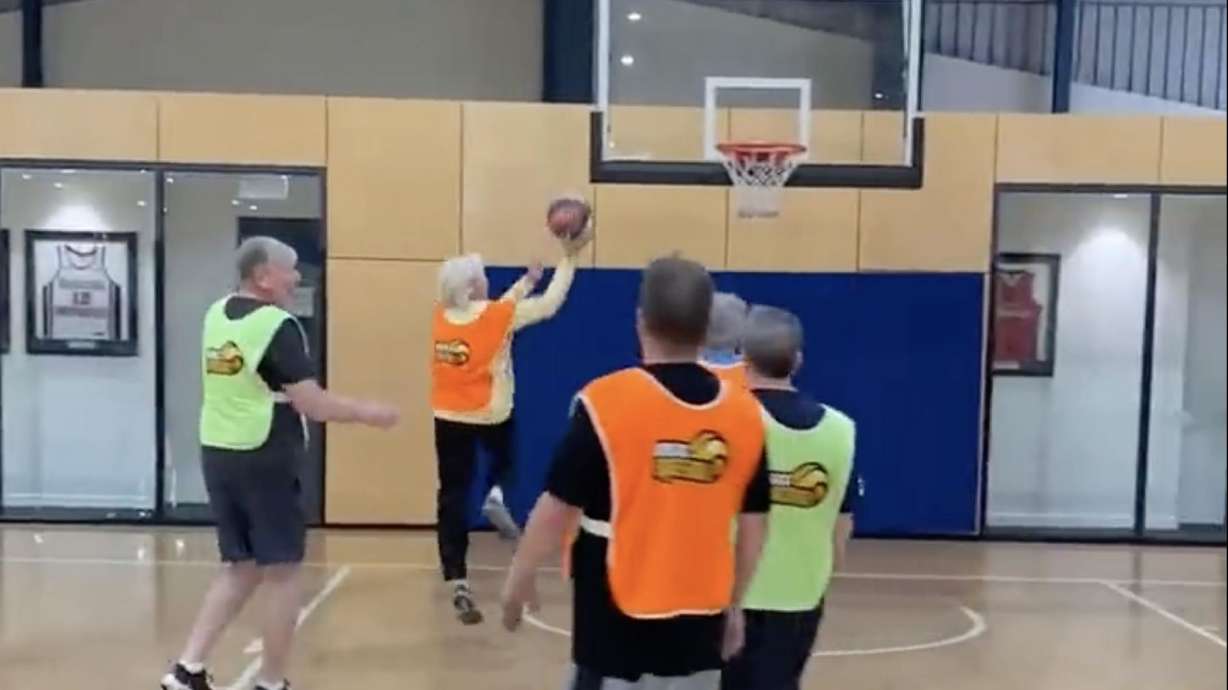 A senior basketball player takes a lay-up in "walking basketball" in Geelong, Australia.