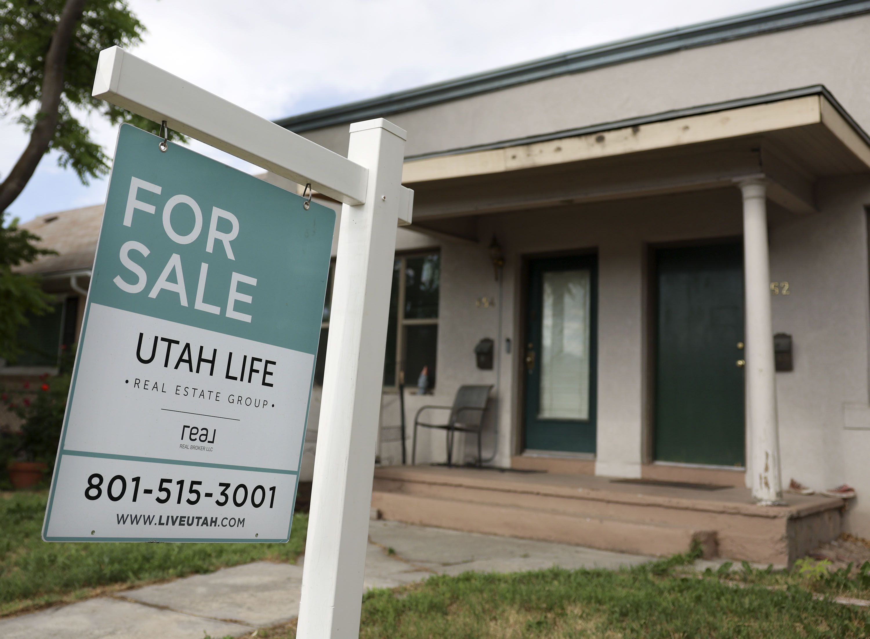 A “For Sale” sign is posted on a property in Salt Lake City on Wednesday, June 29. One housing expert warns of a "tough time" ahead for home builders as data continues to show the national housing market slowing down.