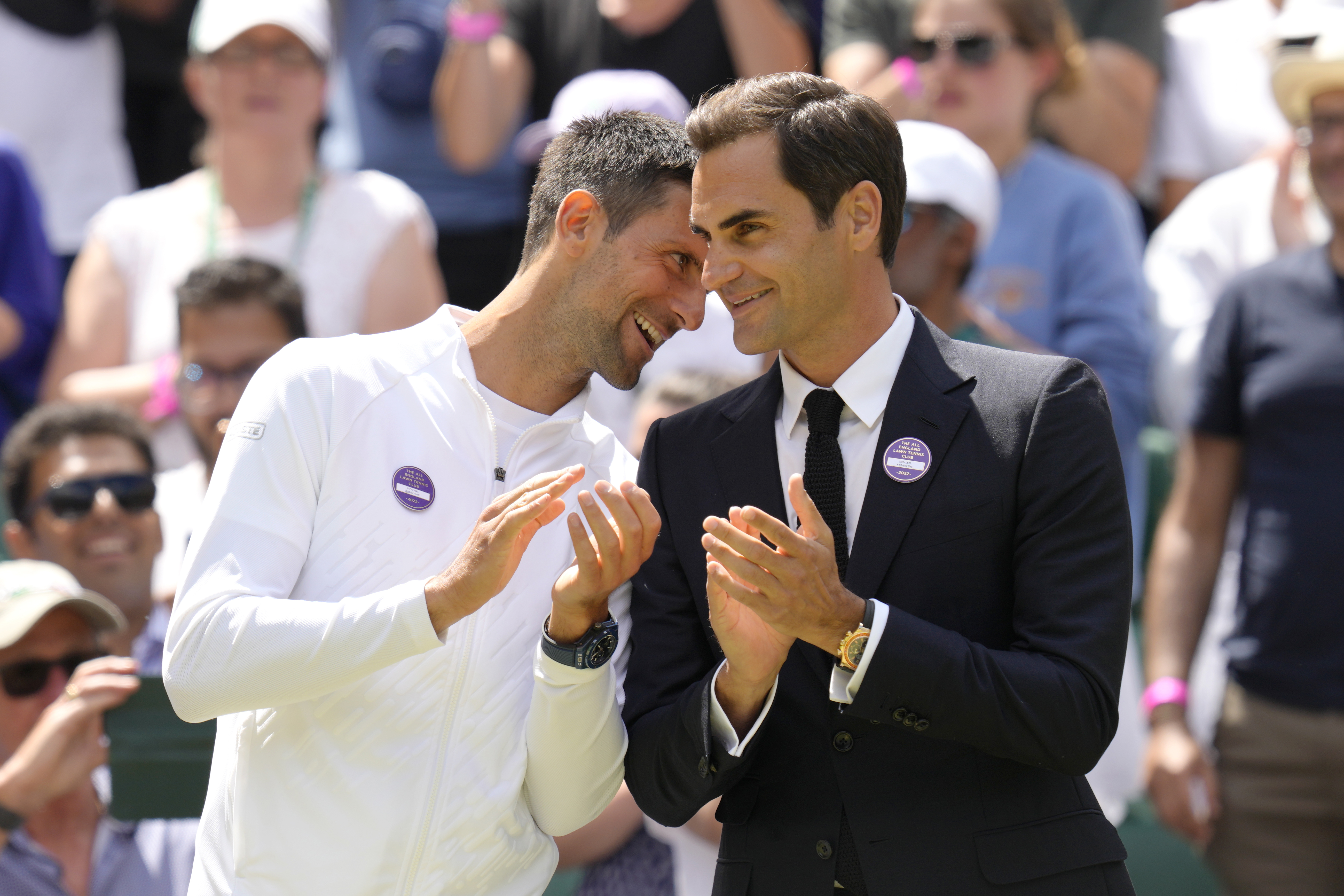 Serbia's Novak Djokovic and Switzerland's Roger Federer speak during a 100 years of Centre Court celebration on day seven of the Wimbledon tennis championships in London, Sunday, July 3, 2022. 