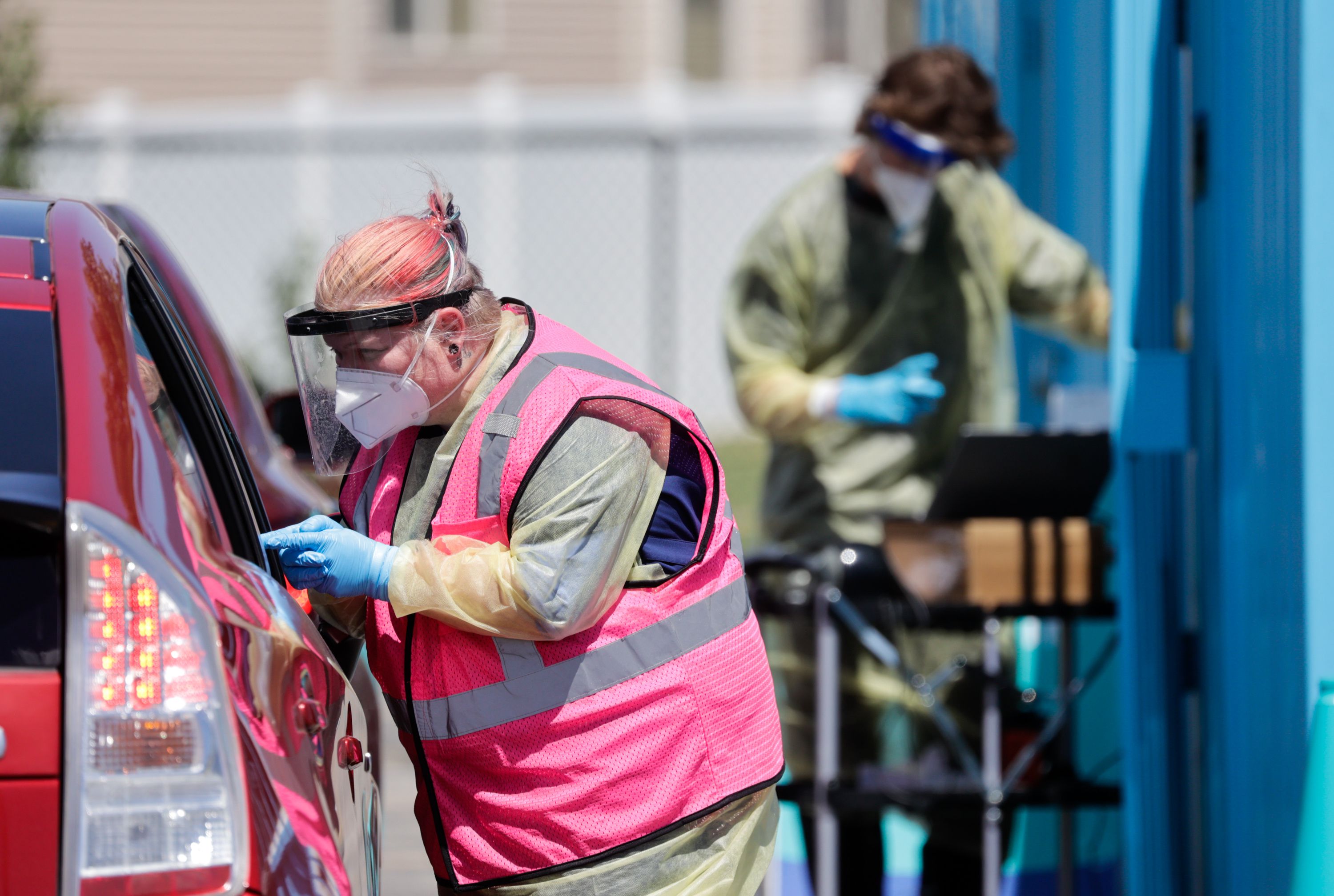 Megan Clay gives a patient a COVID-19 test in West Valley City on Wednesday, July 6. Utah health officials on Thursday confirmed 3,538 new COVID-19 cases over the past week, as well as 13 additional deaths.