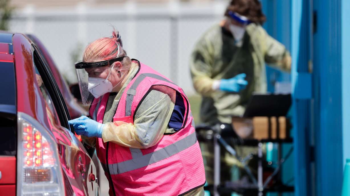 Megan Clay gives a patient a COVID-19 test in West Valley City on July 6. There's something different about the version of COVID-19 that is responsible for a climb in cases and hospitalizations in Utah and the rest of the country.