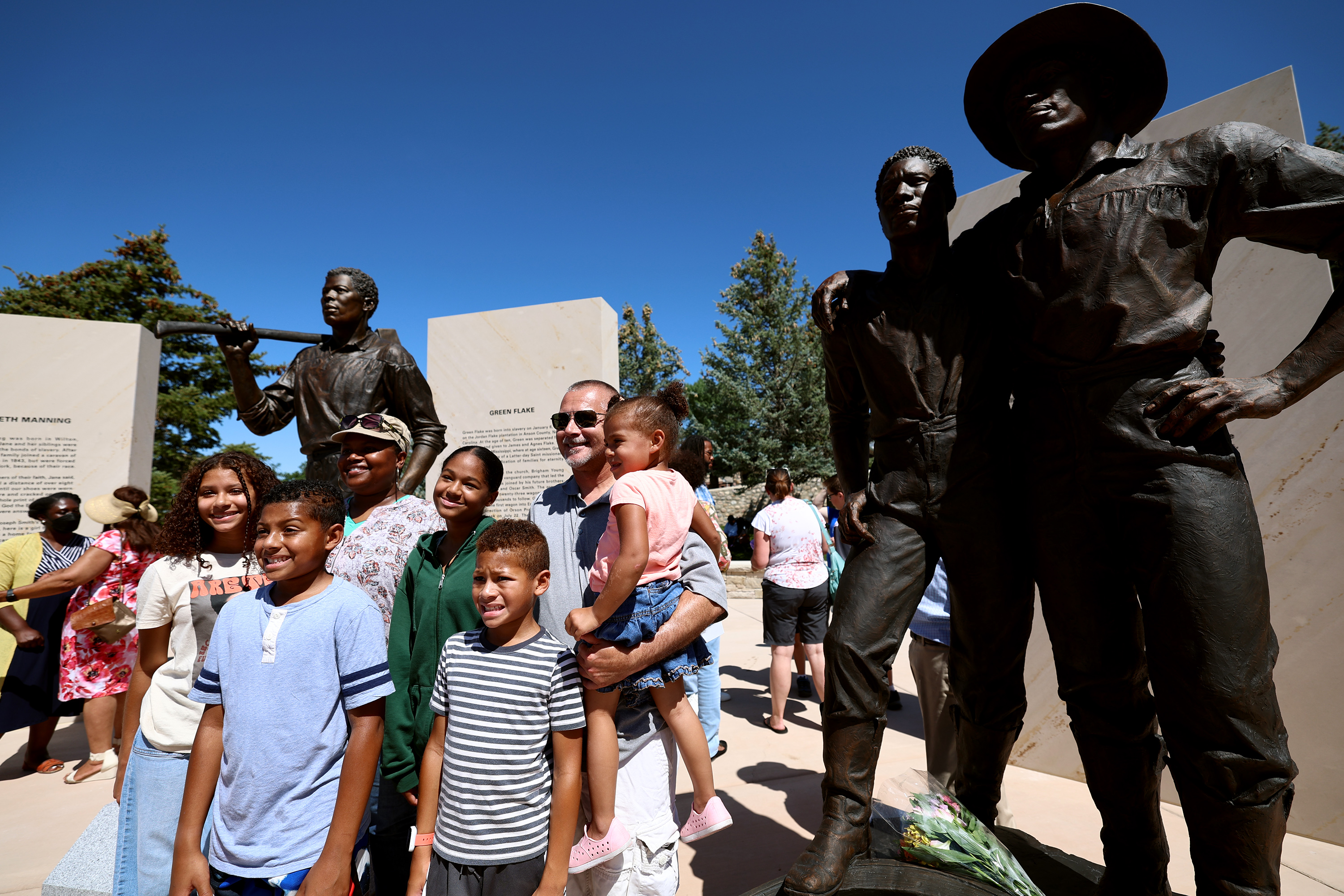 The Sweeney family, from West Valley City, poses for photos at the new Black pioneers monument at This is the Place Heritage Park in Salt Lake City on Friday.