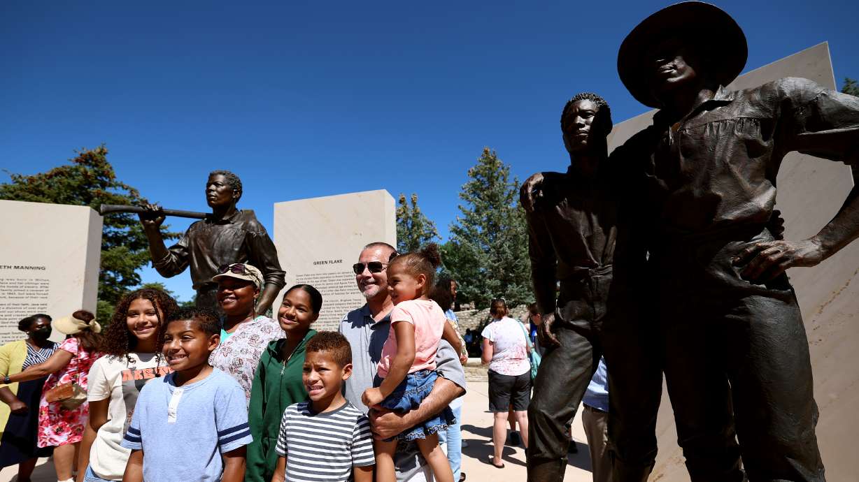 The Sweeney family from West Valley City poses for photos at the Black Pioneer Monument at This Is The Place Heritage Park in Salt Lake City on July 22, 2022. Utah has had a small but vibrant Black community throughout its history.