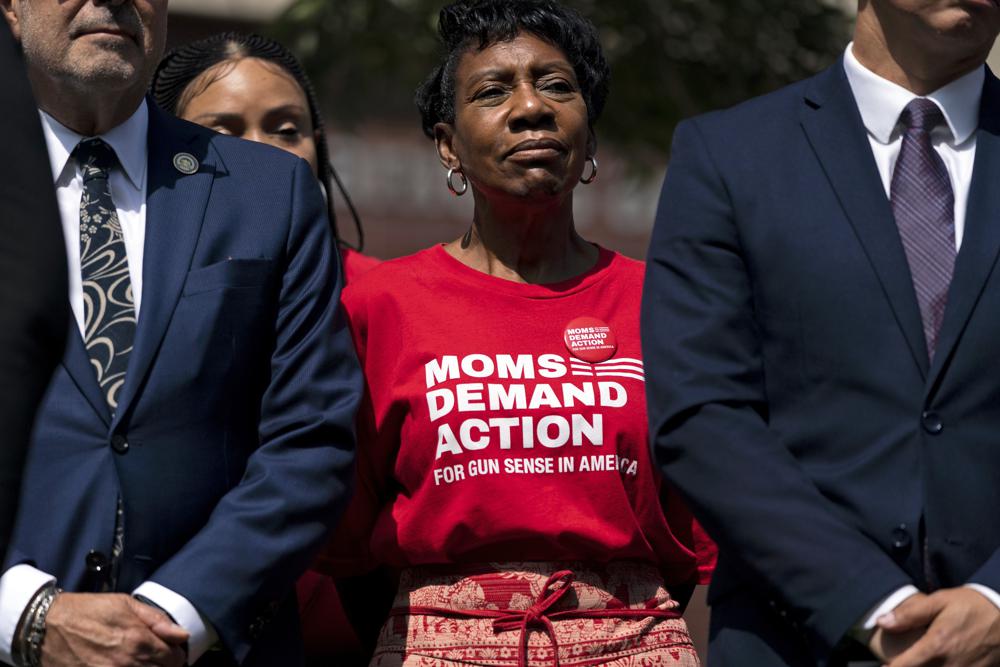 Arvis Jones, center, whose son was killed in gun violence in 2008, attends a news conference by California Gov. Gavin Newsom in Santa Monica, Calif., Friday. Newsom signed a new gun control law Friday, a month after conservative justices overturned women's constitutional right to abortions and undermined gun control laws in states including California.