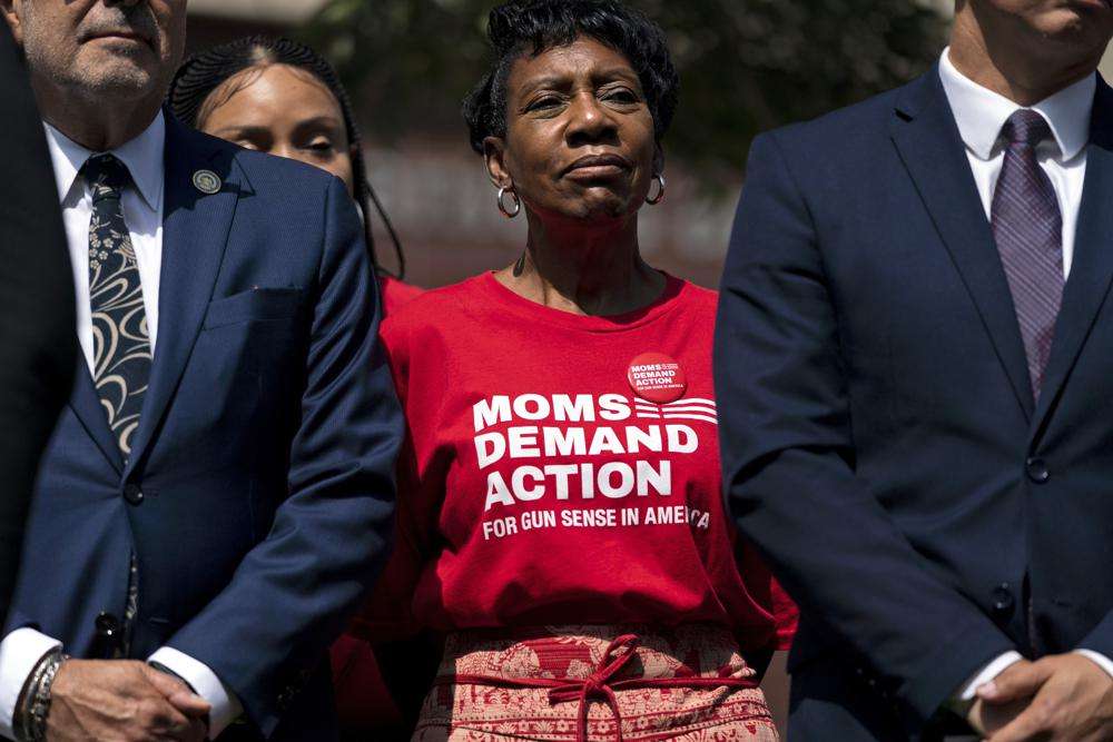 Arvis Jones, center, whose son was killed in gun violence in 2008, attends a news conference by California Gov. Gavin Newsom in Santa Monica, Calif., Friday. Newsom signed a new gun control law Friday, a month after conservative justices overturned women's constitutional right to abortions and undermined gun control laws in states including California.