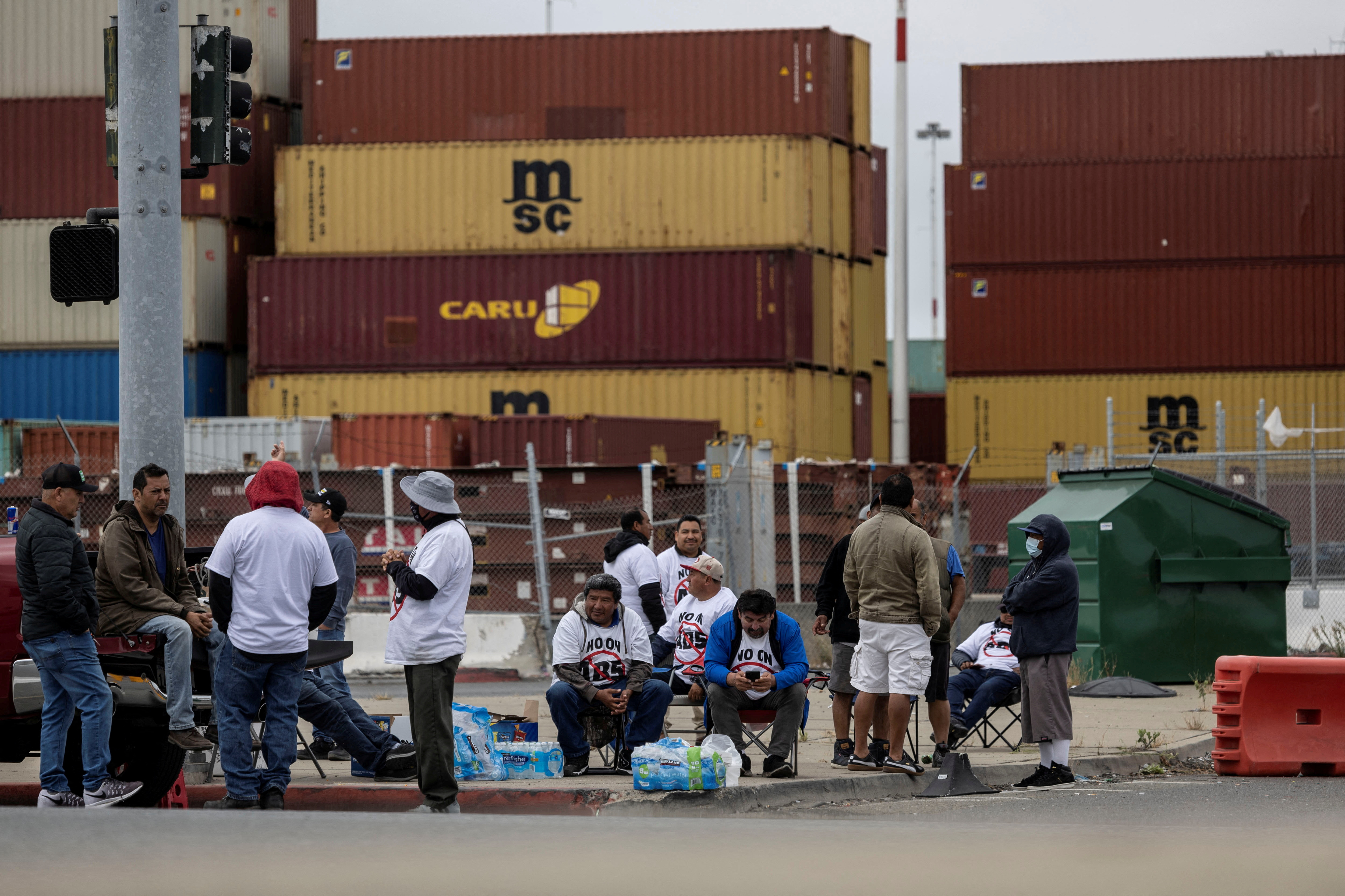 Truck drivers gather to block the entrance of trucks at a container terminal at the Port of Oakland, during a protest against California's law known as AB5, in Oakland, California, Thursday. Independent truckers protesting California's new "gig worker" law blockaded California's No. 3 seaport for the third-straight day on Friday.