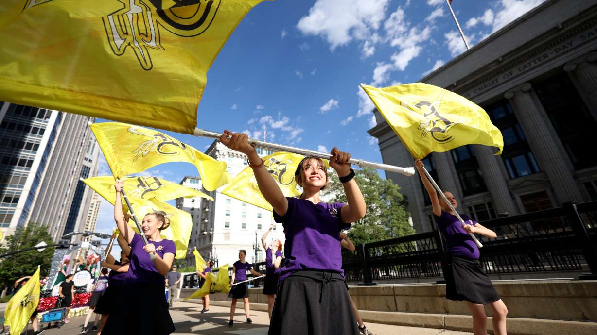 Emma Brando practices with the Davis High School color guard before the start of the Days of ’47 Parade in Salt Lake City on Saturday.