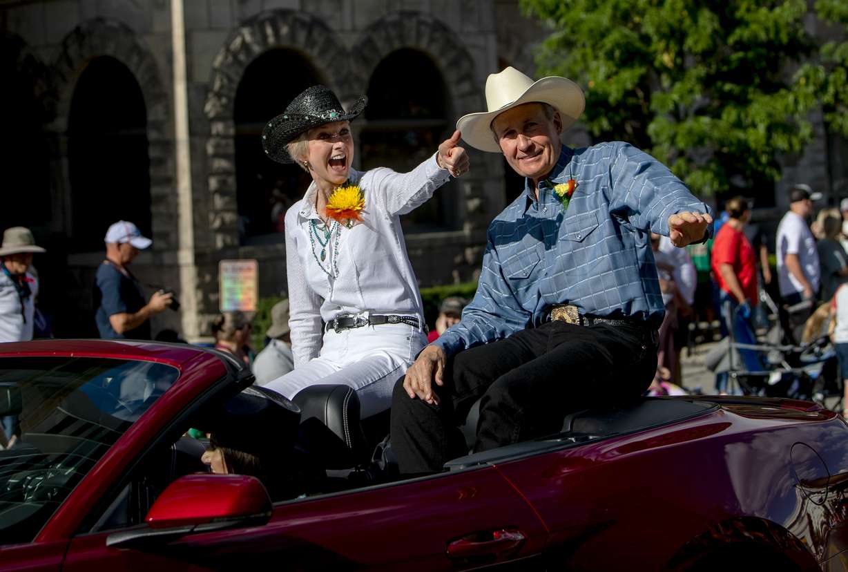 Grand Marshal of the '47 Days Parade, Relief Society President Jean B. Bingham of The Church of Jesus Christ of Latter-day Saints, and her husband, Bruce Bingham, greet parade attendees Saturday in Salt Lake City.