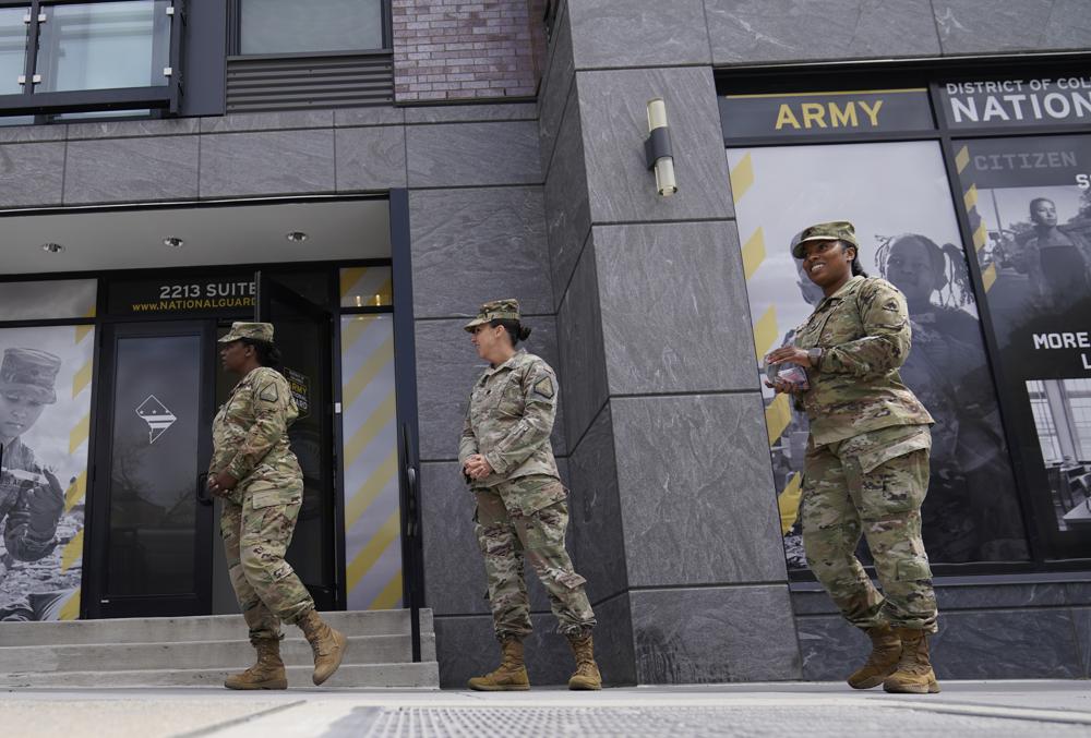 The U.S. Army National Guard members stand outside the Army National Guard office during training April 21, in Washington. In March the local guard opened its first proper recruiting office in the city since 2010. The Army is significantly cutting the total number of soldiers it expects to have in the force over the next two years.