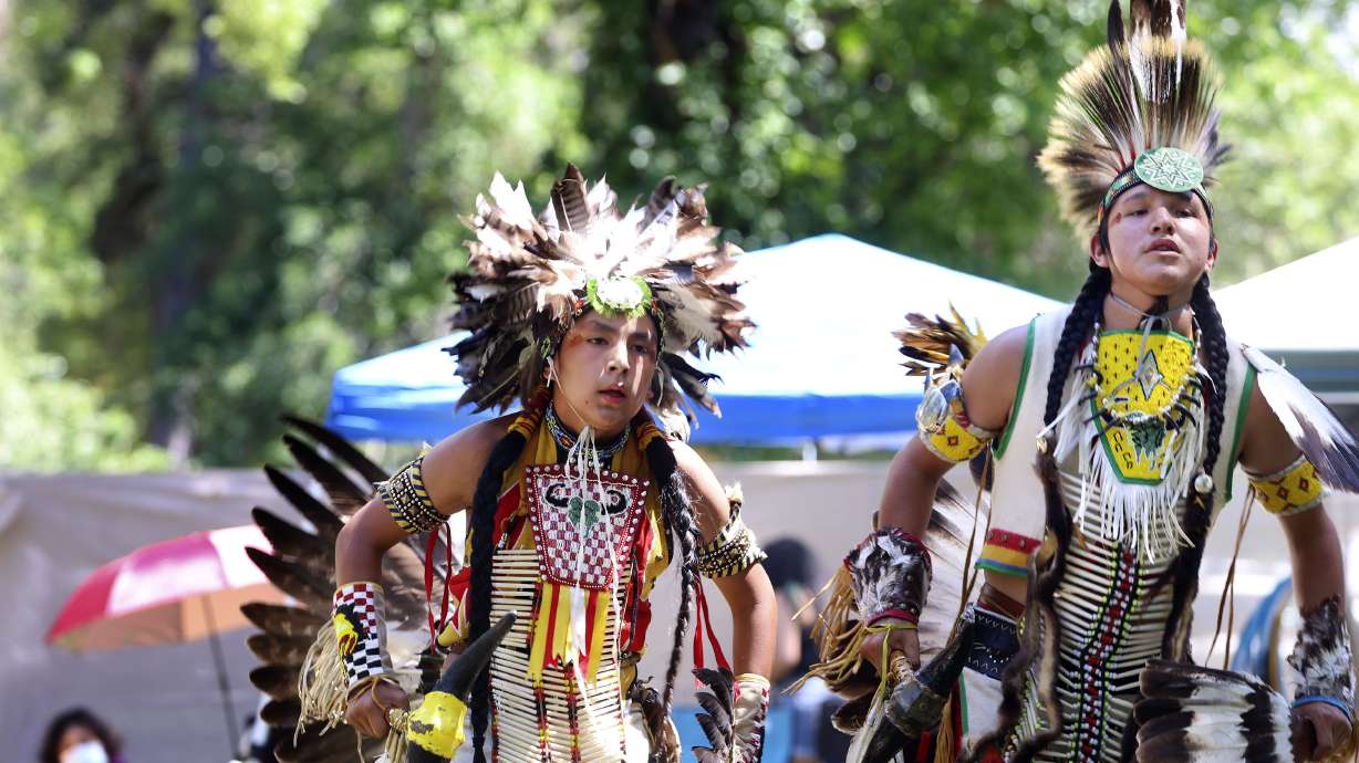 Stephan Brown and Nakoa Kakakaway, both from McDermott, Nevada, dance during the 28th Annual Intertribal Powwow in Liberty Park in Salt Lake City on Saturday.