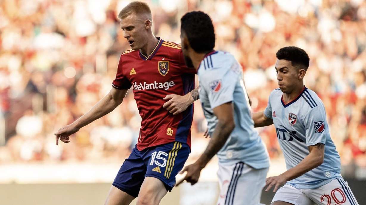 Justen Glad fights off Jesus Ferreira, middle, in the RSL-FC Dallas matchup at Rio Tinto Stadium Saturday.