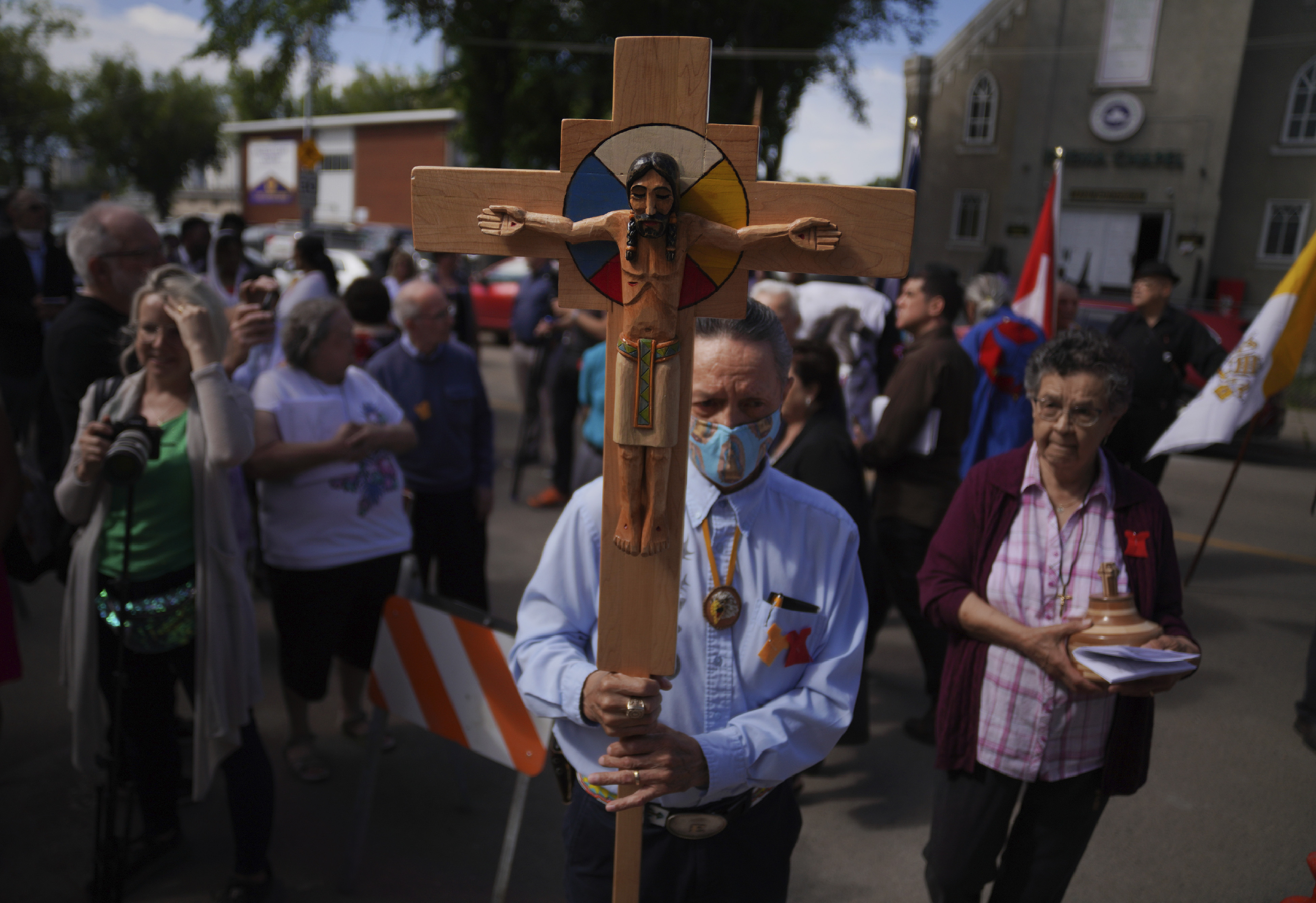 Elmer Waniandy raises the crucifix at Sacred Heart Church of the First Peoples sanctuary on July 17 in Edmonton, Alberta. Pope Francis’ trip to Canada, which begins Sunday, to apologize for the horrors of church-run Indigenous residential schools marks a radical rethink of the Catholic Church’s missionary legacy in the Americas. 