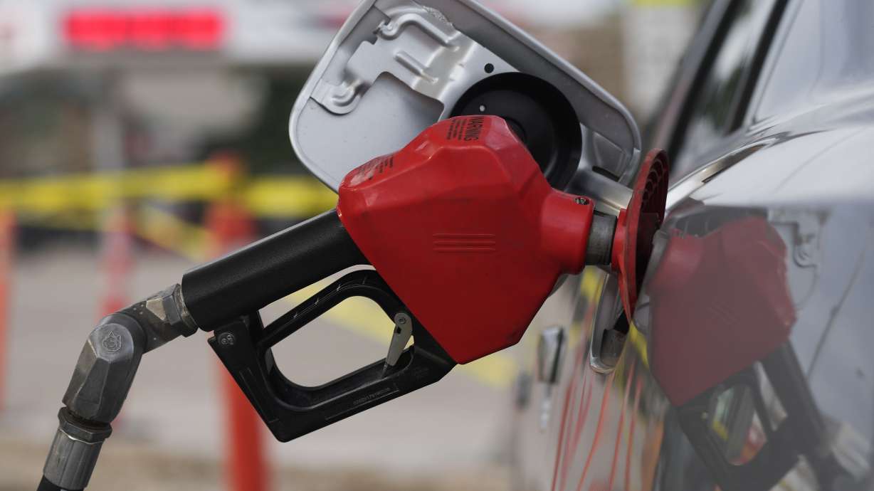 A motorist fills up the tank on a sedan Friday in Saratoga, Wyo. The average U.S. price of regular-grade gasoline plunged 32 cents over the past two weeks to $4.54 per gallon.