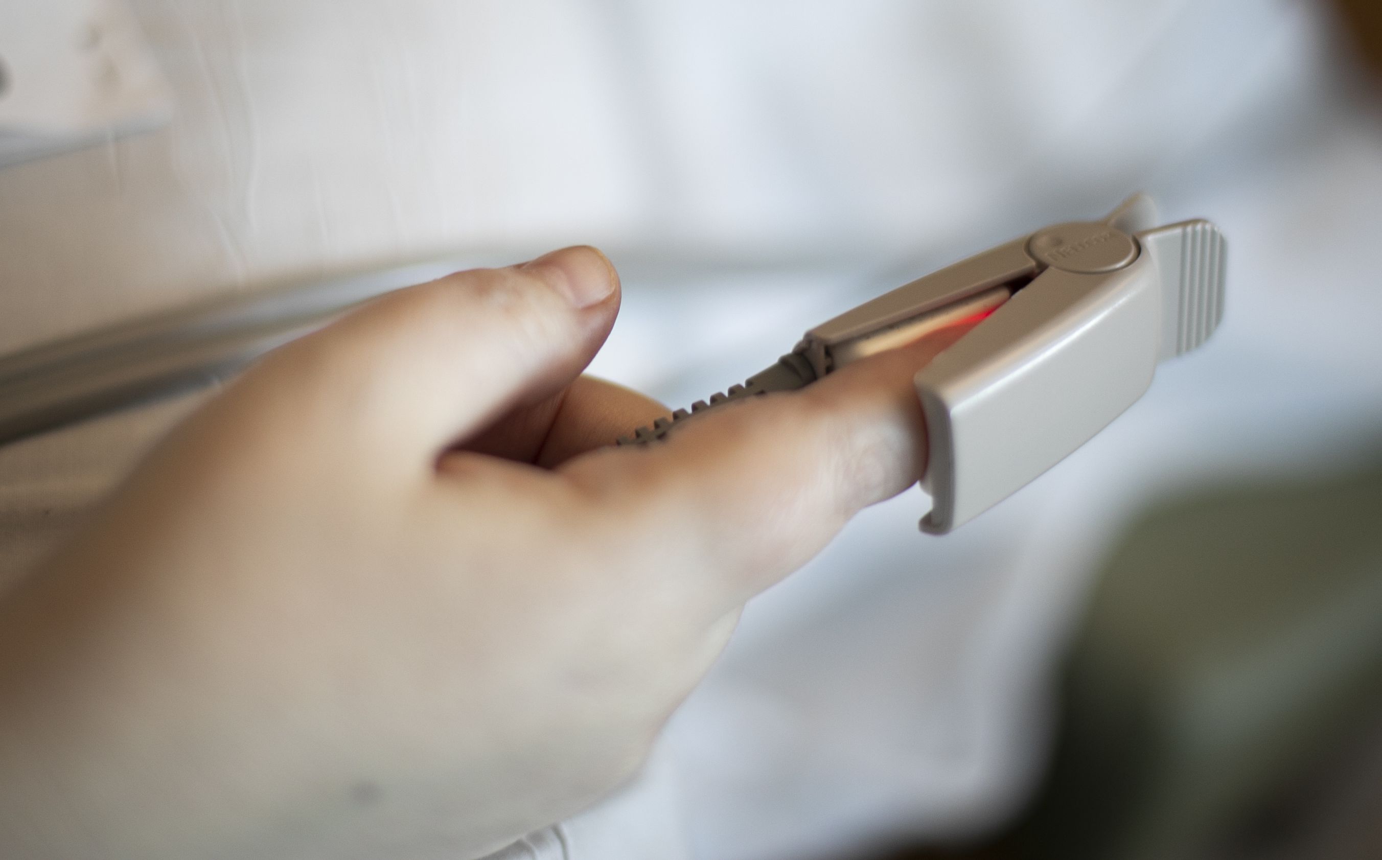 In this Aug. 8, 2020, photo a pulse oximeter is used to check a patient’s oxygen saturation level at a hospital in Portland, Ore. New studies have questioned accuracy of pulse oximeters in some people of color.