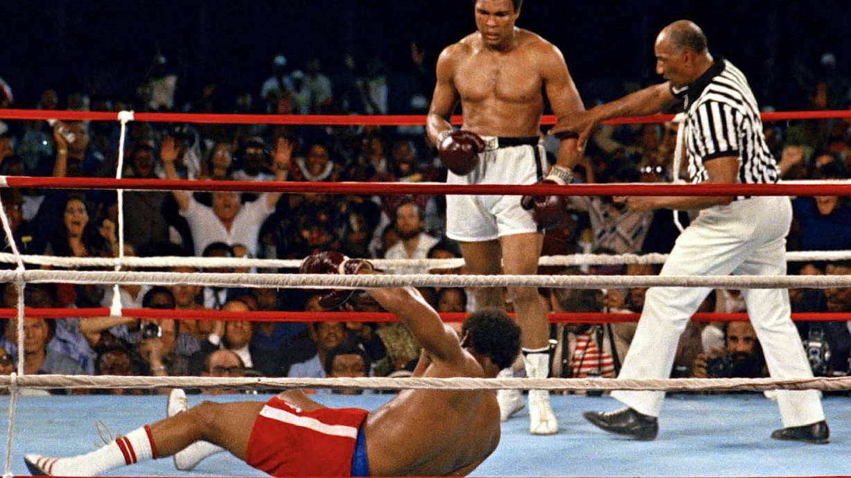 FILE - Referee Zack Clayton, right, steps in after challenger Muhammad Ali, second from right, knocked down defending heavyweight champion George Foreman, bottom, in the eighth round of their championship bout on Oct. 30, 1974, in Kinshasa, Zaire. Ali’s championship belt from the 1974 “Rumble in the Jungle” heavyweight title fight was sold at auction on Sunday, July 24, 2022, for $6.18 million.
