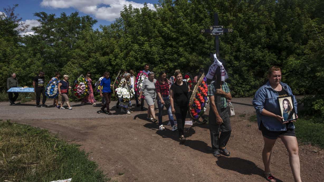 Family and friends of 35-year-old Anna Protsenko, who was killed in a Russian rocket attack, walk to a cemetery for her burial, during her funeral procession, on the outskirts of Pokrovsk, eastern Ukraine, July 18. Protsenko was killed two days after coming home. She had done what authorities wanted, evacuating eastern Ukraine's Donetsk region as Russian forces move closer, but starting a new life elsewhere was uncomfortable and expensive.