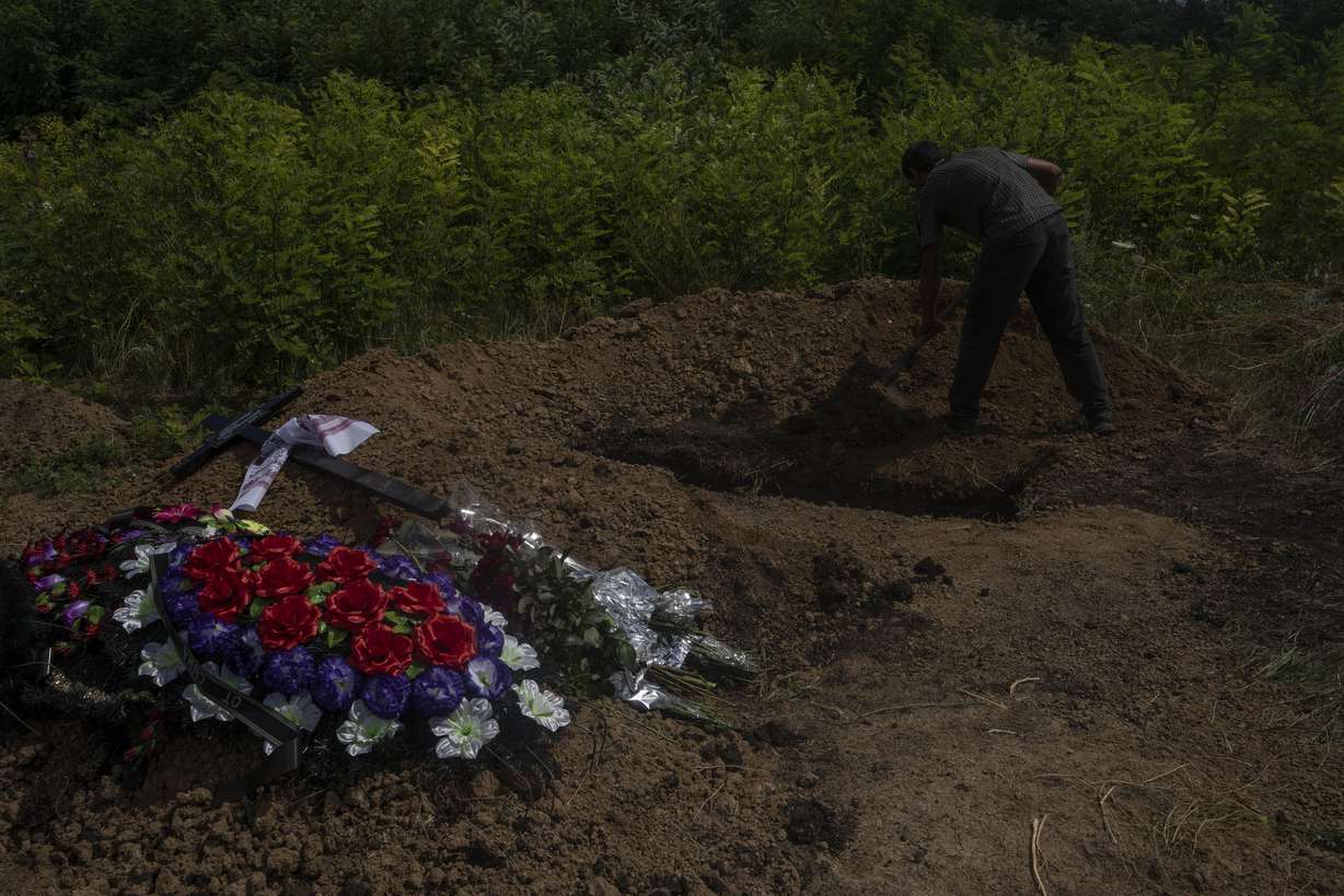 A gravedigger shovels soil on the casket of 35-year-old Anna Protsenko, who was killed in a Russian rocket attack, during her burial, on the outskirts of Pokrovsk, eastern Ukraine, July 18. Protsenko was killed two days after coming home. She had done what authorities wanted, evacuating eastern Ukraine's Donetsk region as Russian forces move closer, but starting a new life elsewhere was uncomfortable and expensive.