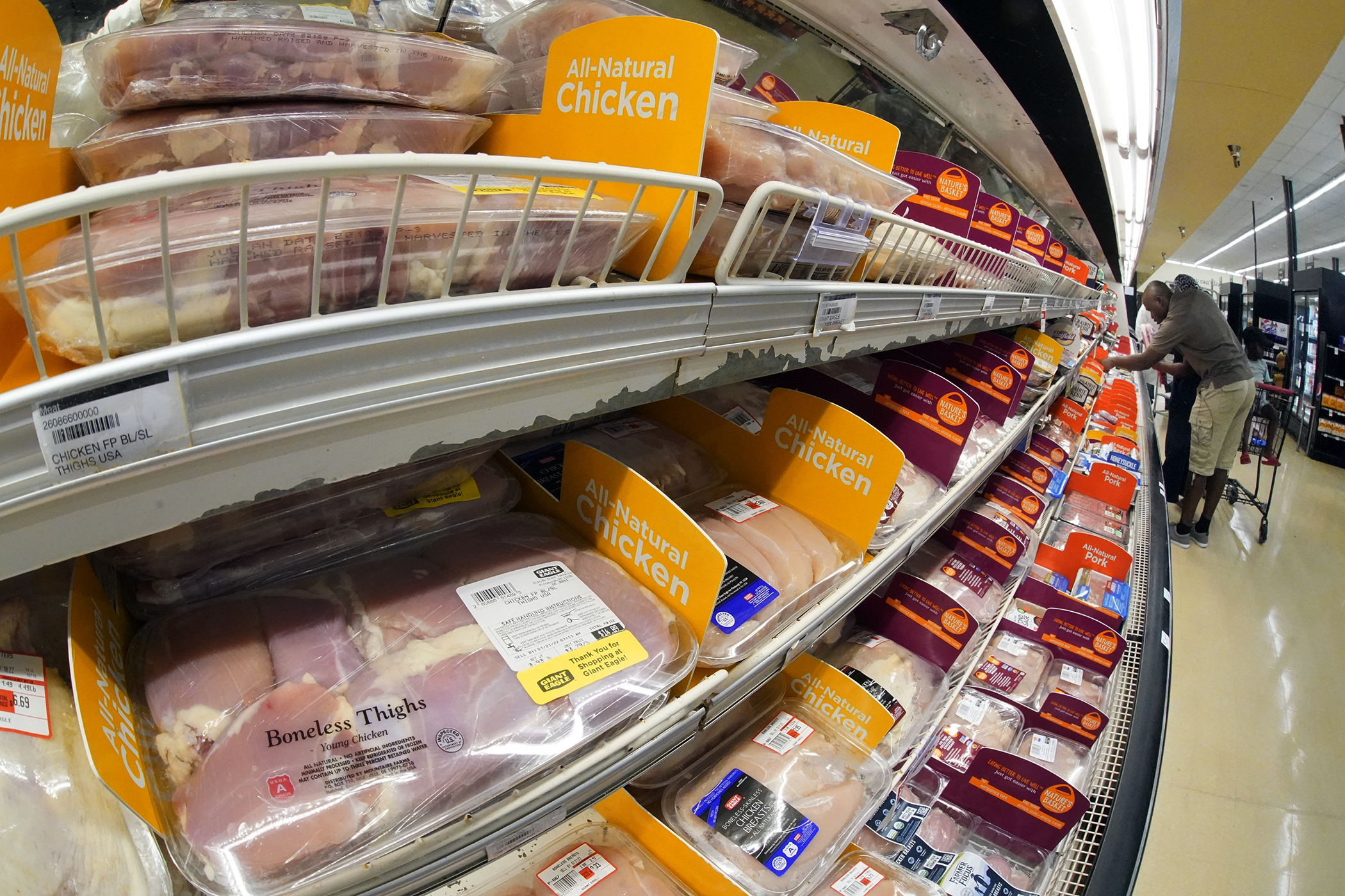 Chicken is on display in a market in Pittsburgh, July 12. The Justice Department is expected to file a lawsuit and proposed settlement against some of the largest poultry producers in the U.S. It's part of an effort to end what the government claims have been longstanding deceptive and abusive practices for workers. 