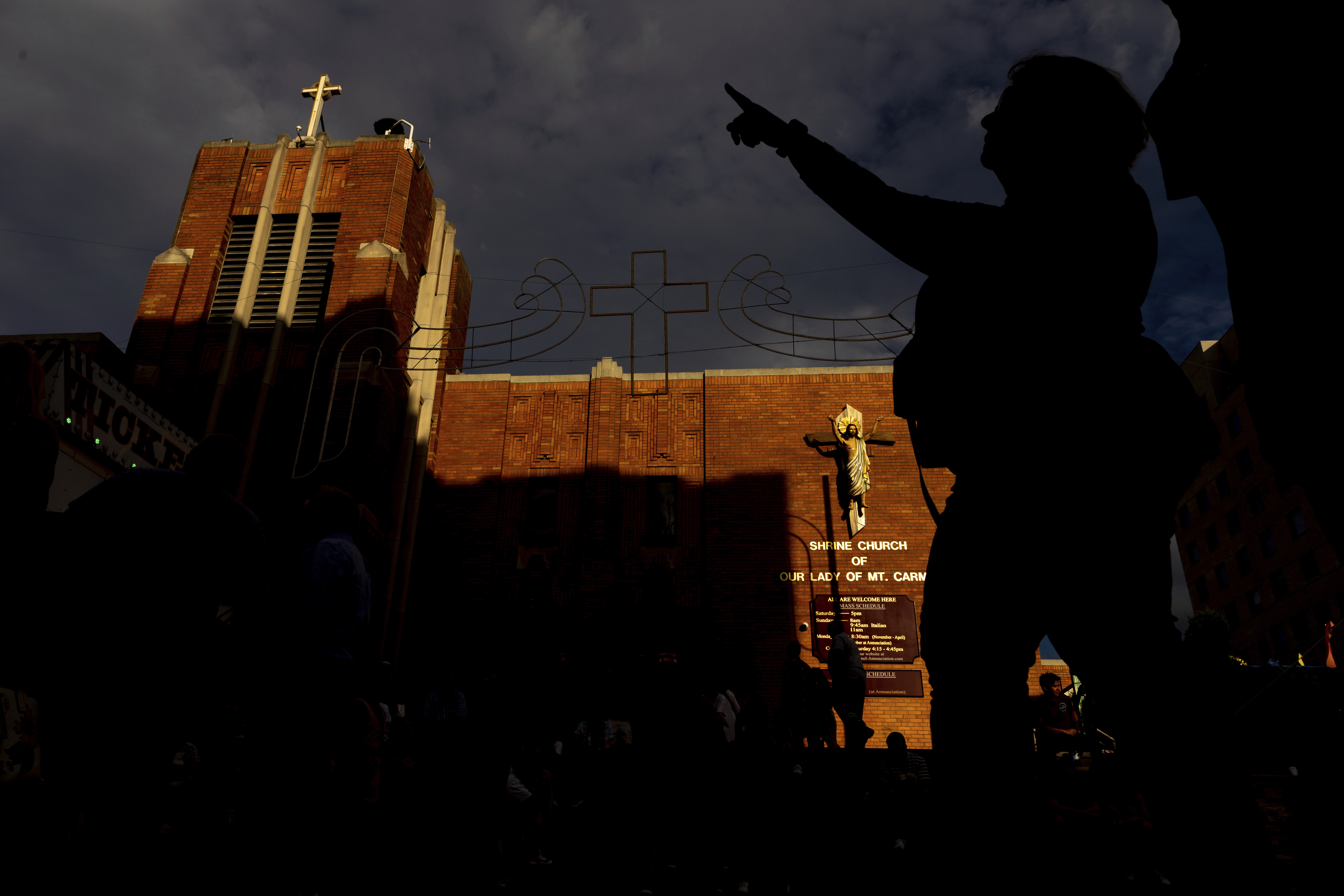 People walk past the Shrine Church of Our Lady of Mount Carmel, July 6, 2022, in the Brooklyn borough of New York. Frank Carone, who caused Monsignor Jamie Gigantiello to be stripped of his duties for letting Sabrina Carpenter film a provocative video at the church, was arrested on Wednesday.