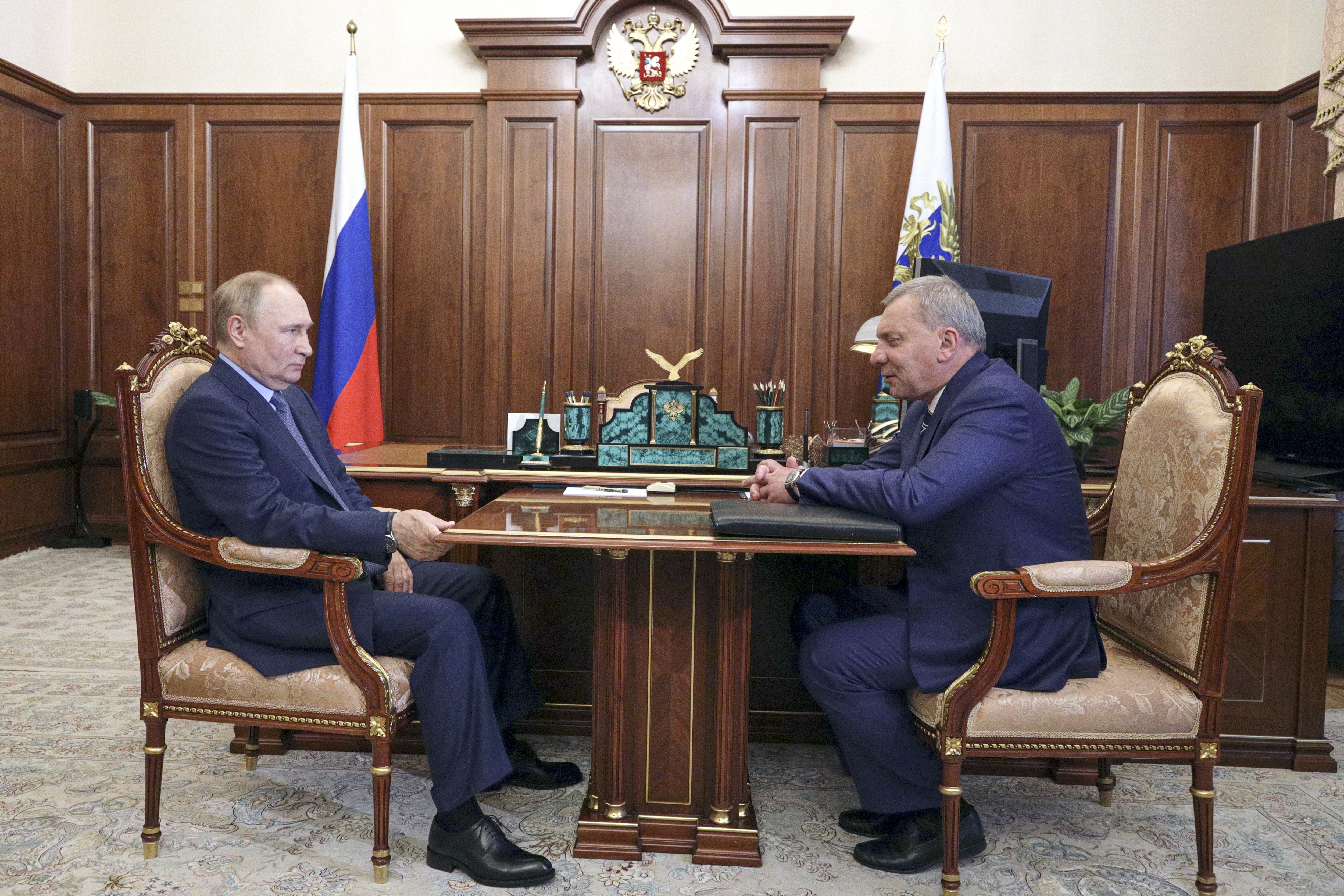 Russian President Vladimir Putin, left, listens to Yuri Borisov, the new CEO of the Russian State Space Corporation "Roscosmos," at the Kremlin in Moscow, Russia, Tuesday.